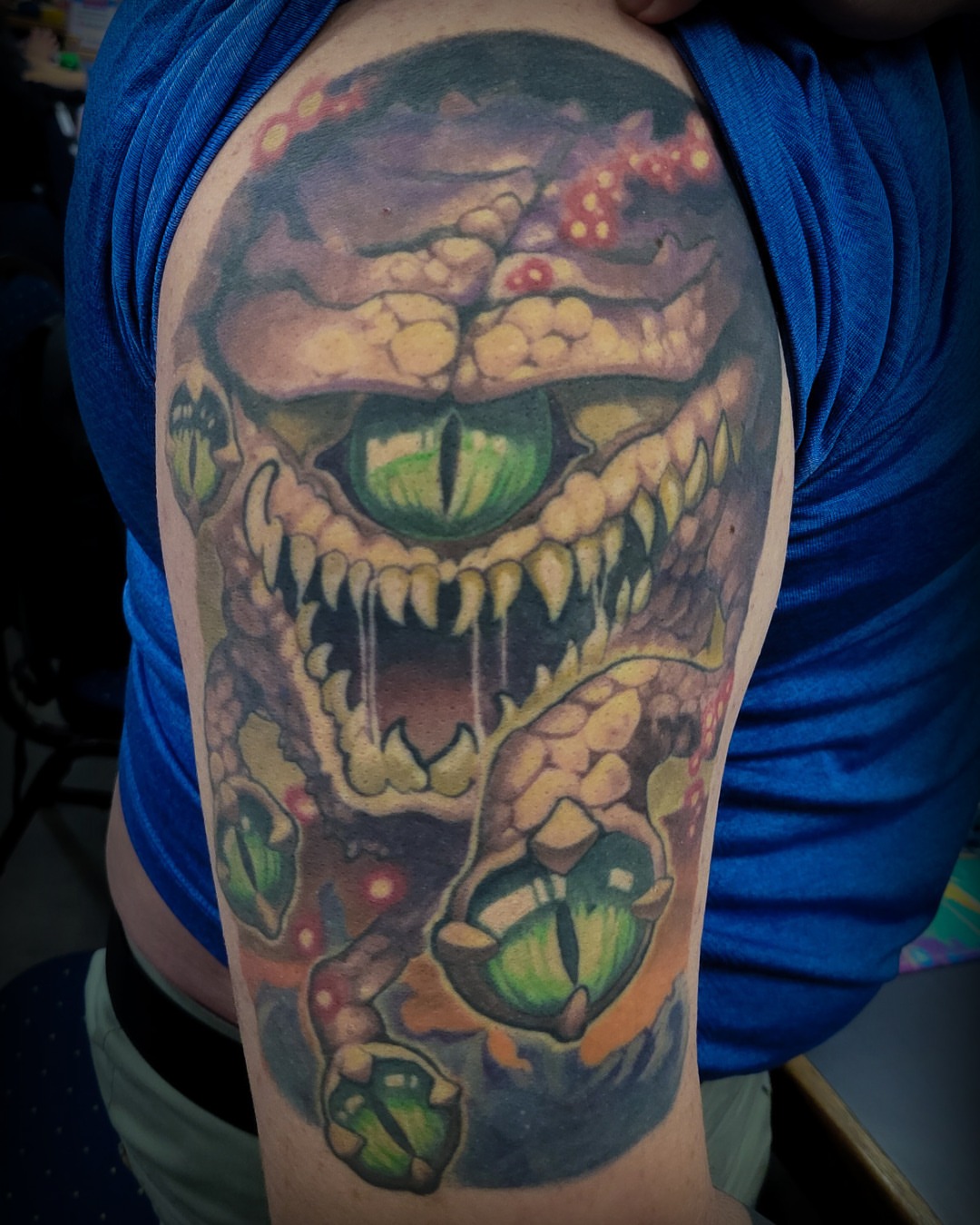 Monster dark realism tattoo on the upper arm by Bo