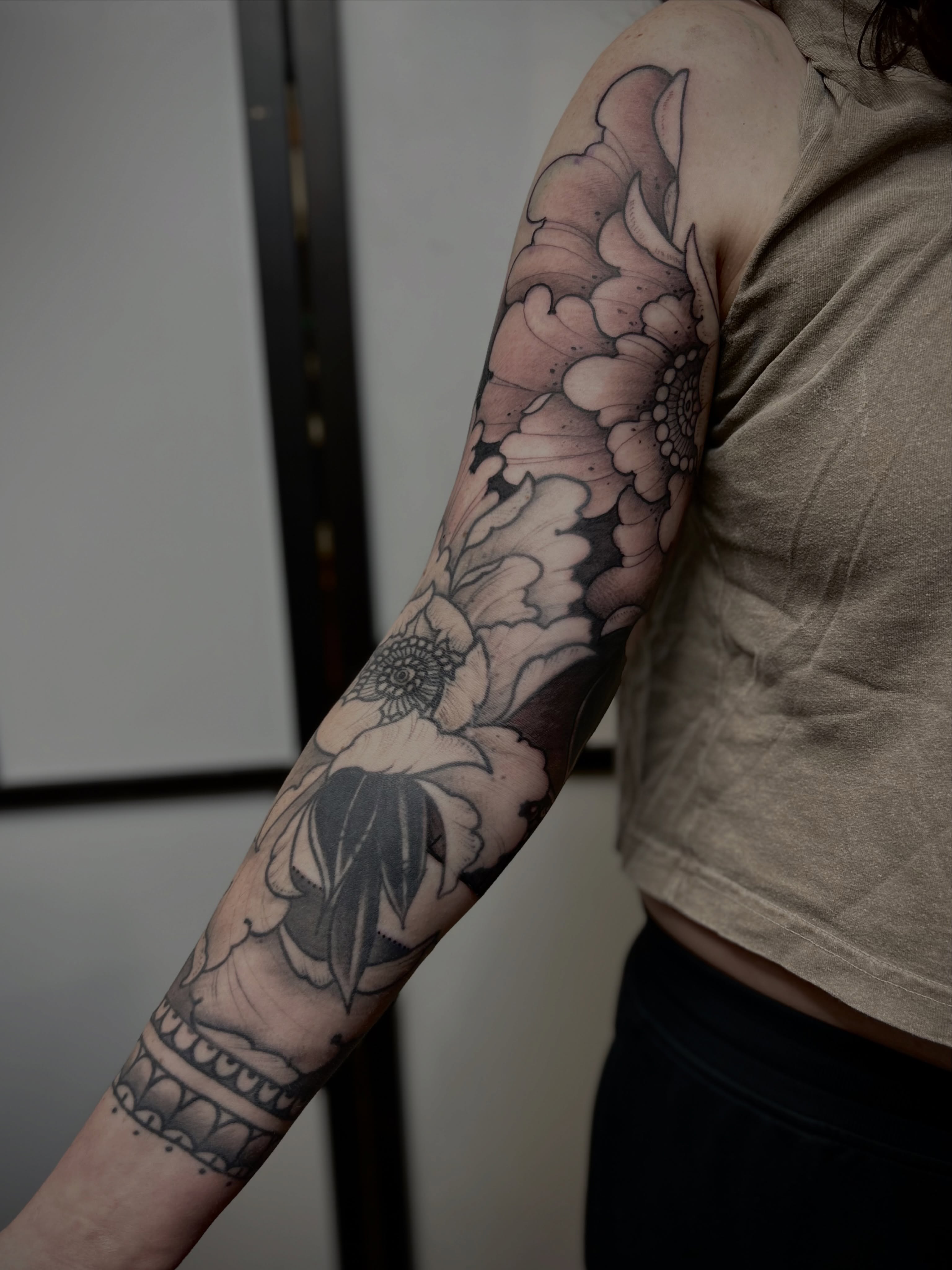 Floral design black and grey tattoo on the forearm by Ryan Willard, Denver, Colorado