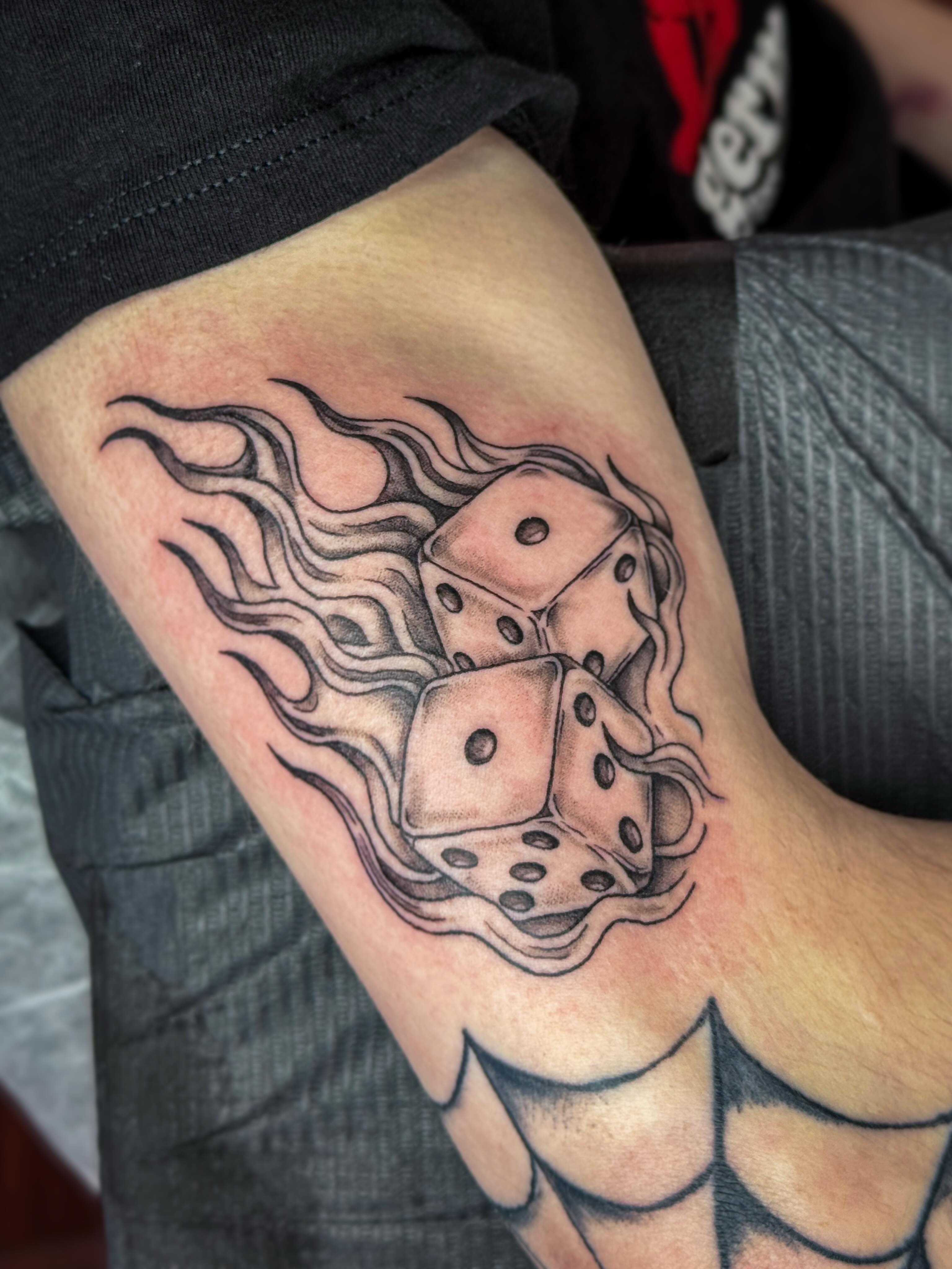 Dice black and grey tattoo on the forearm by Ash✨