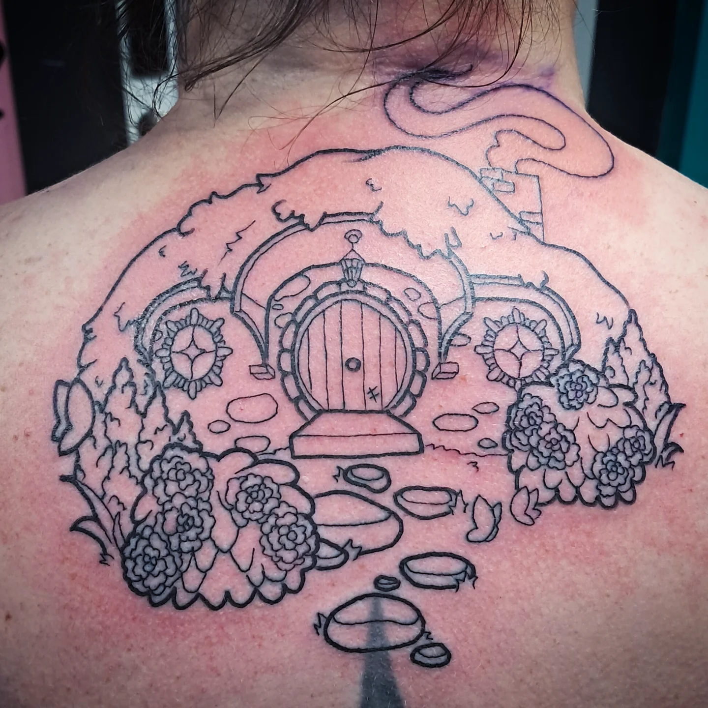 Hobbit door black and grey tattoo on the back by Erika Hollingsworth