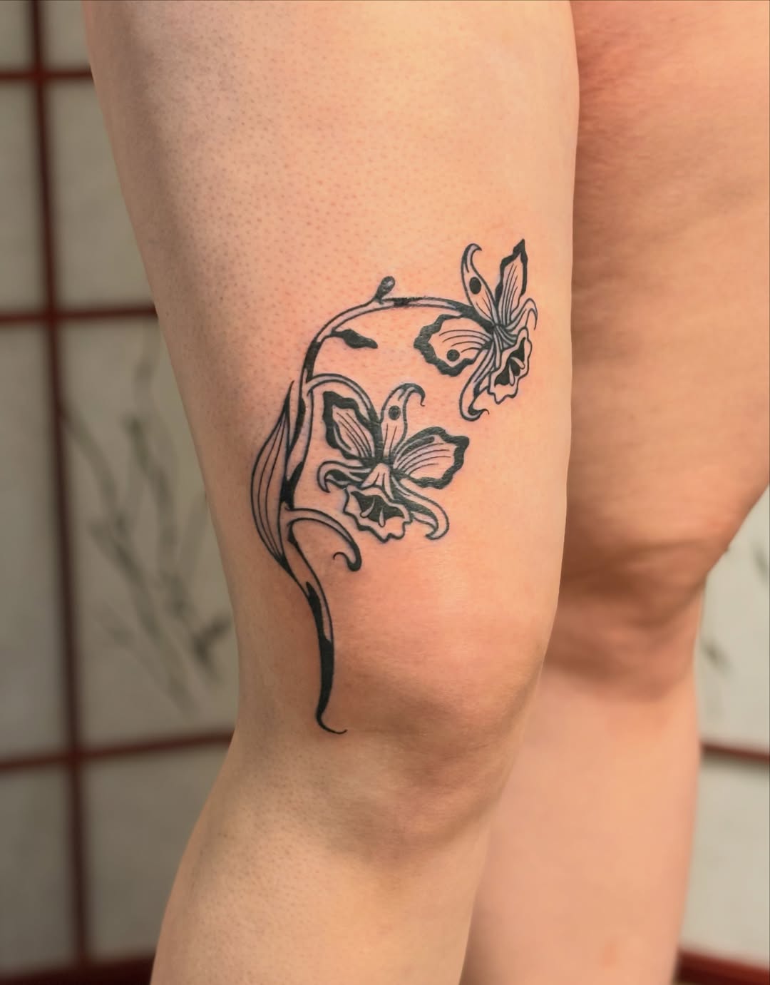 Flowers fine line tattoo on the calf by CJ
