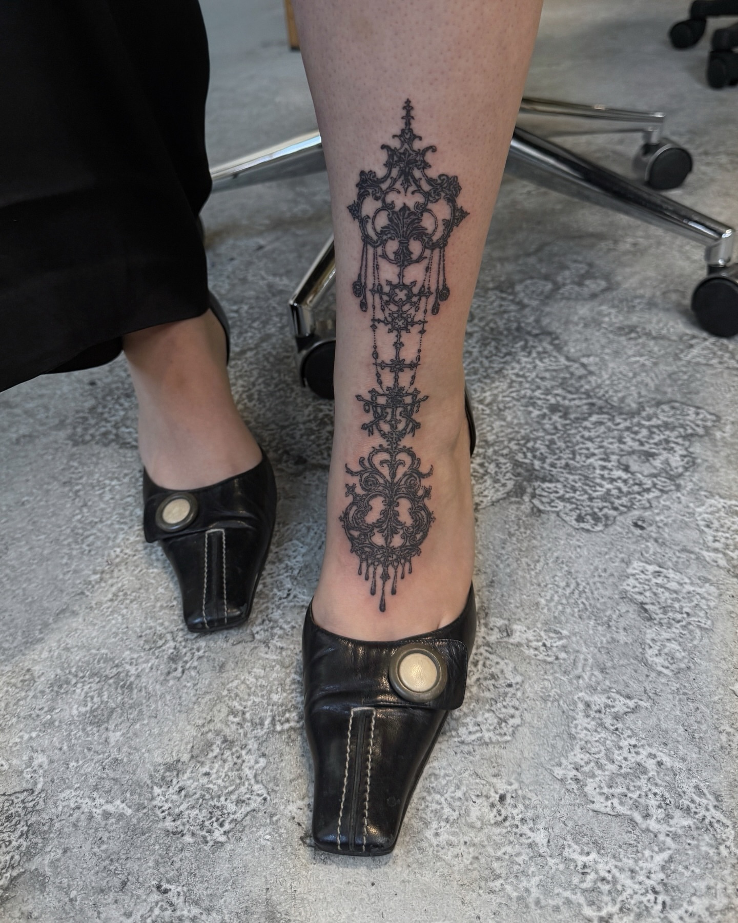 Lace cross black and grey tattoo on the calf by Penelope