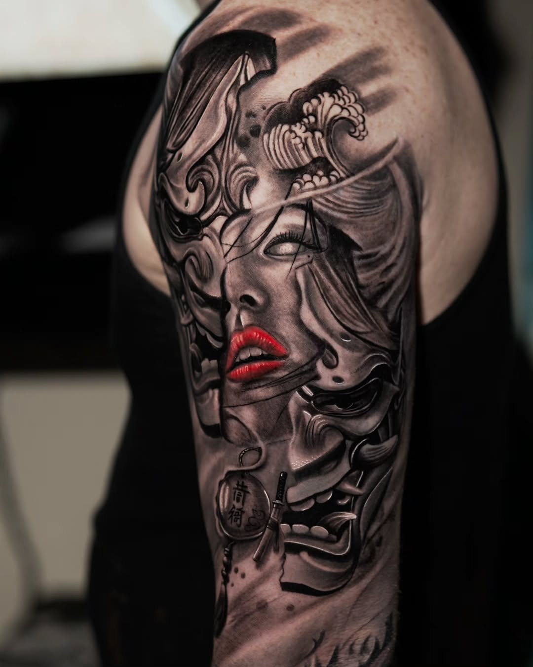 Geisha and oni masks Japanese tattoo on the shoulder by Baxtertattoo
