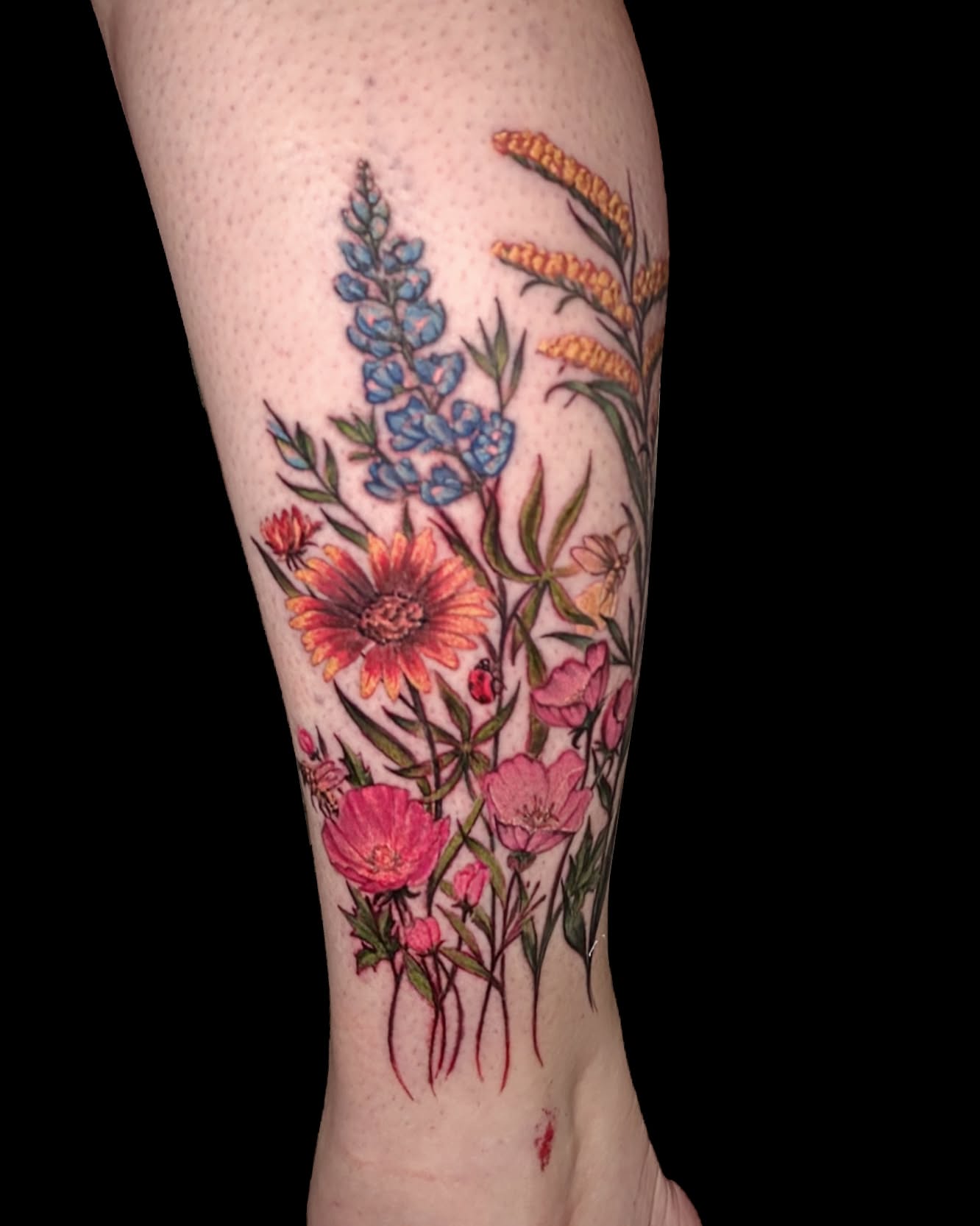 Wildflowers and insects realism tattoo on the calf by Dallas Tattoo Artist Erik Espinoza