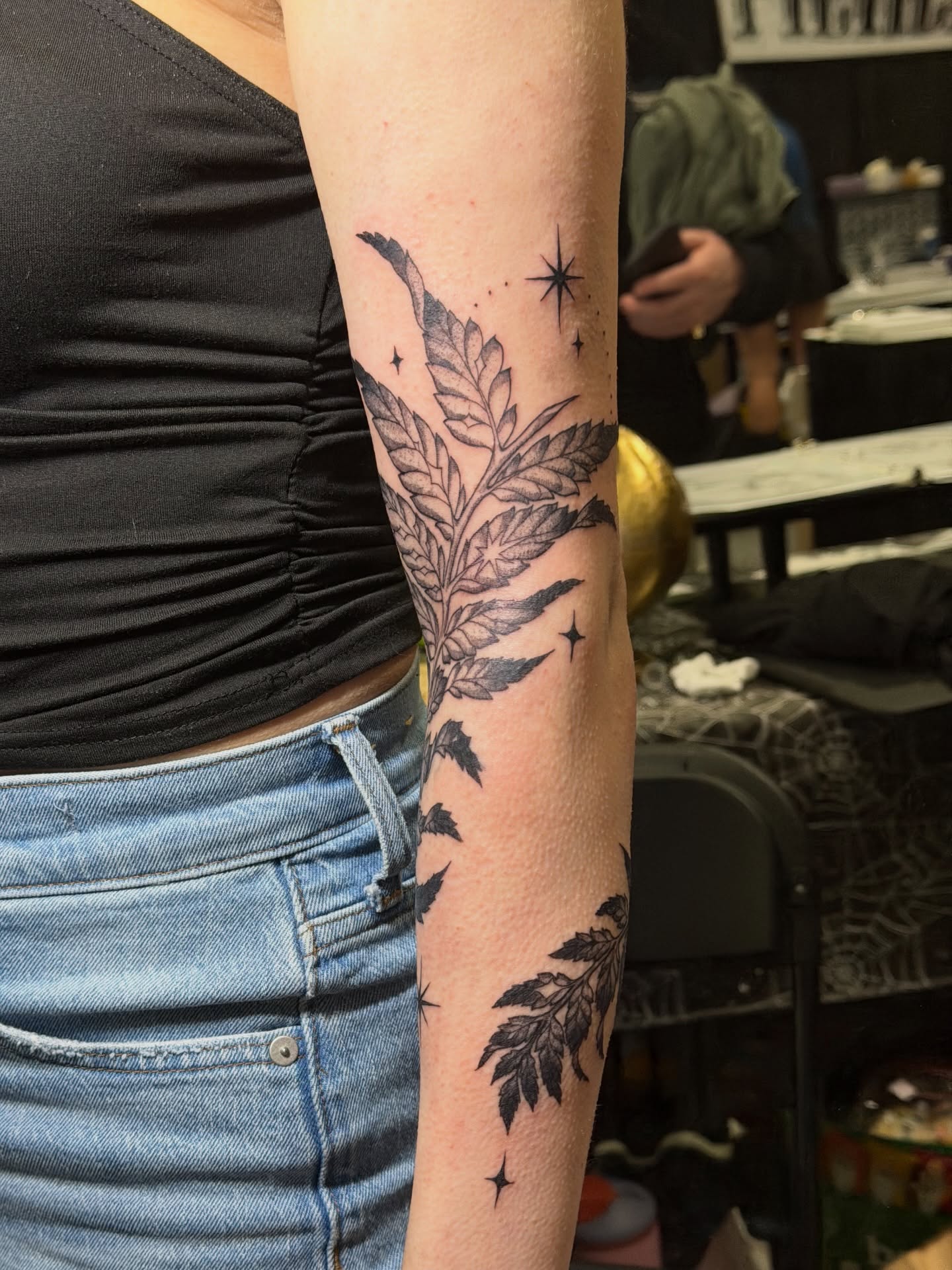 Fern leaves black and grey tattoo on the forearm by Gianna Calisi