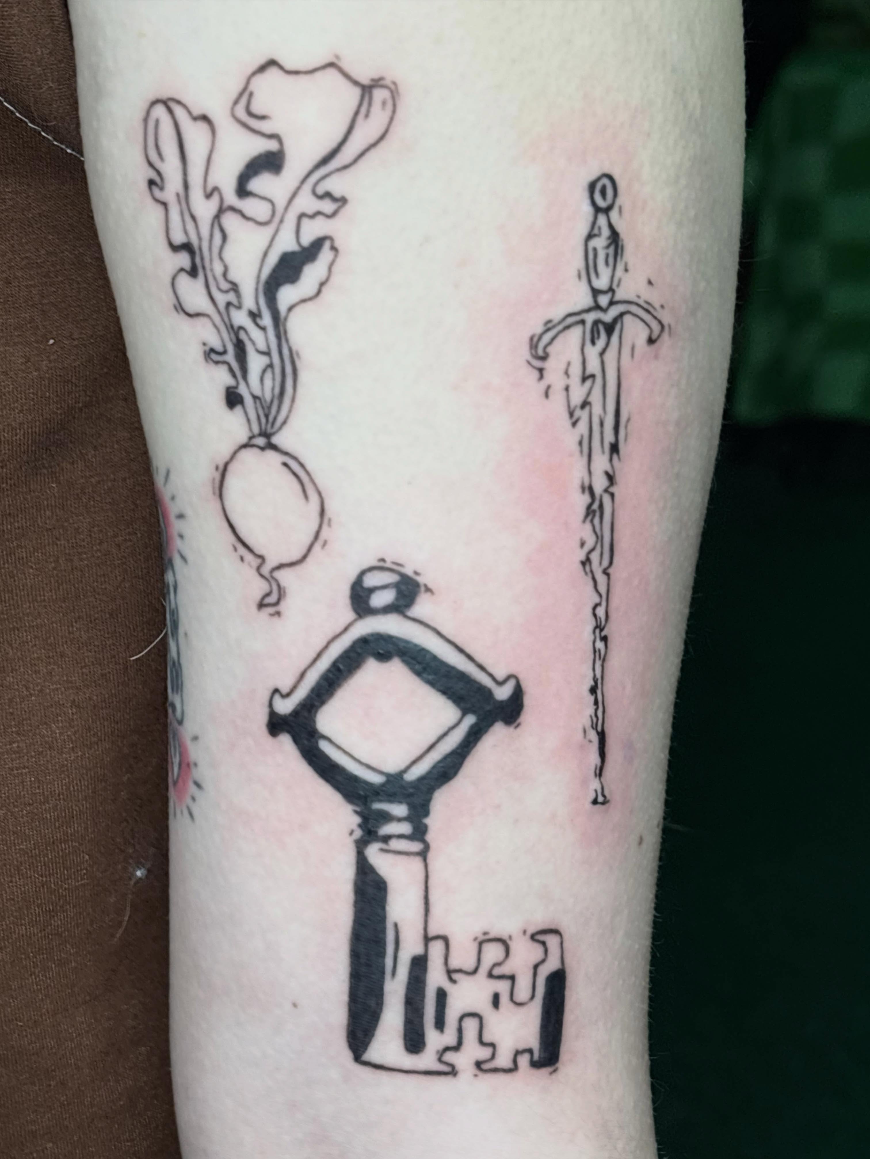 Key, sword, plant black and grey tattoo on the forearm by Hiro Robinson