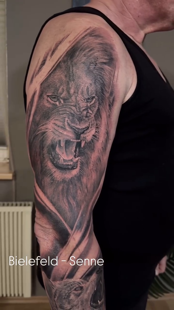 Lion's head sleeve realism tattoo on the upper arm by Die Ivo, Bielefeld, Germany