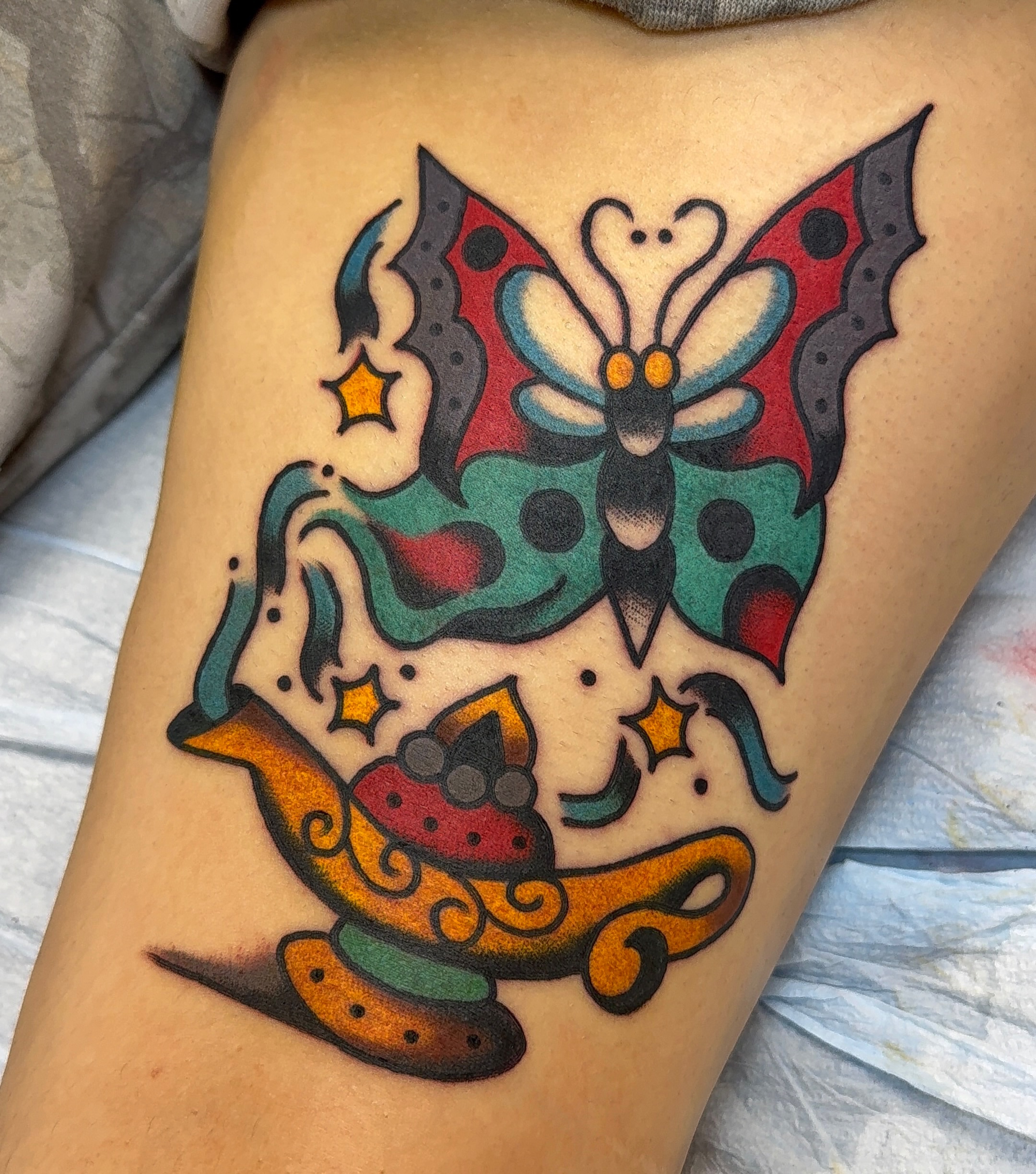 Butterfly and teapot American traditional tattoo on the thigh by VAY