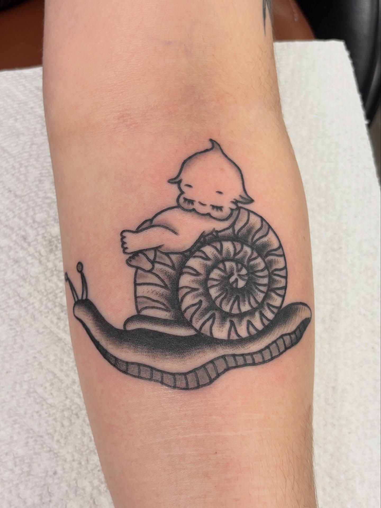 Snail and baby black and grey tattoo on the forearm by Aysia Mankin-Wong, San Francisco, California