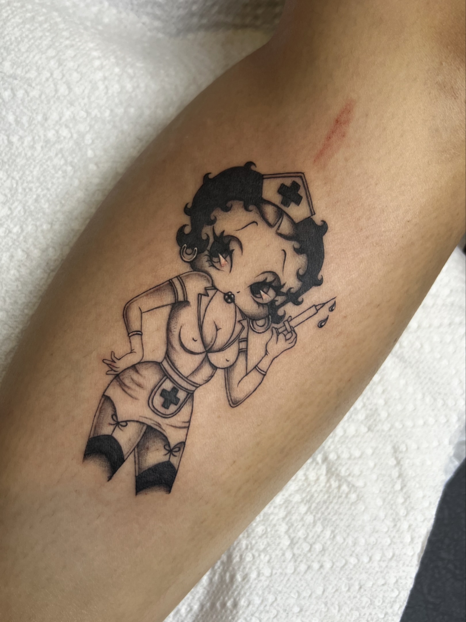 Betty Boop nurse black and grey tattoo on the forearm by ๐ฏ๐๐๐๐๐๐๐๐ ๐ฒ๐๐๐๐๐๐๐ โ โ๐พ๐๐ฎ๐ด๐ฌโ โ