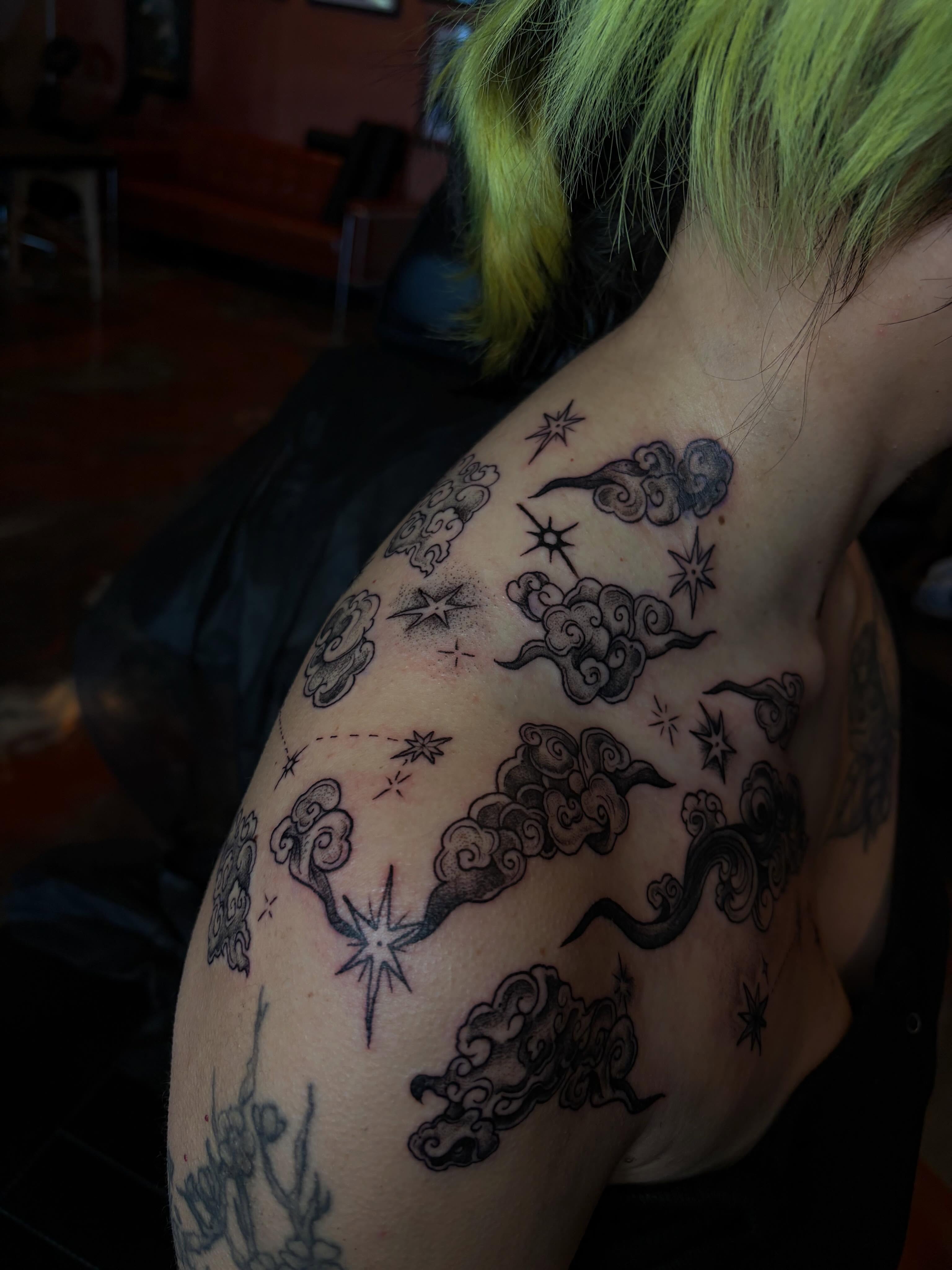 Clouds and stars black and grey tattoo on the shoulder by destany aguilera, Davenport, Iowa