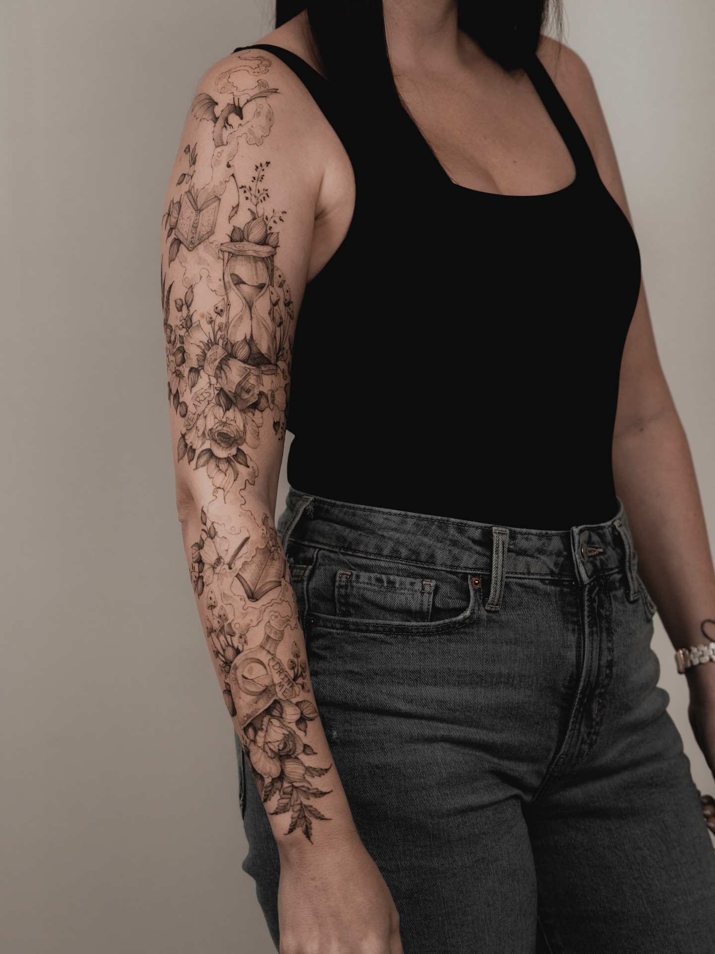 Floral bouquet black and grey tattoo on the upper arm by Marek