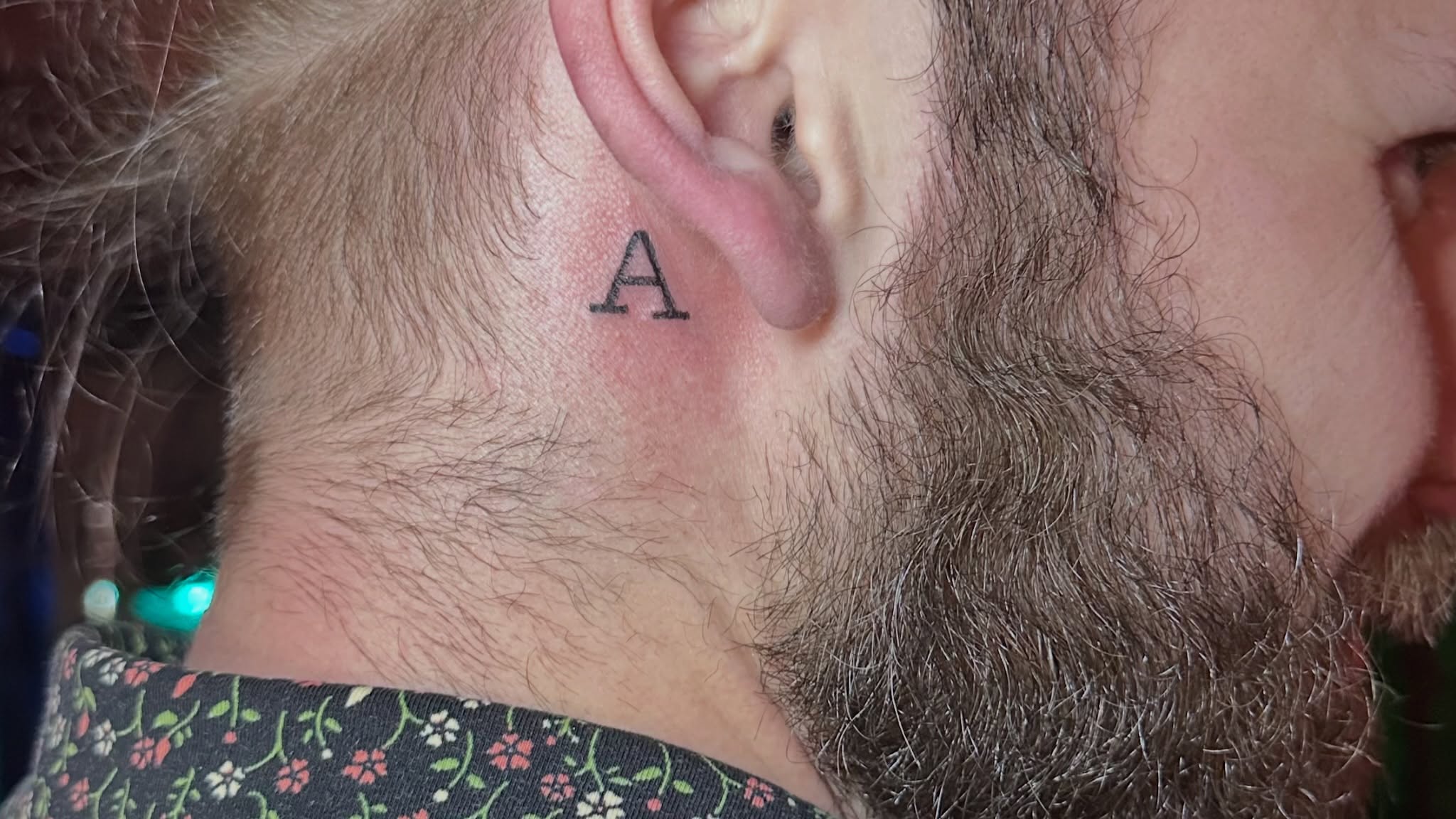 Letter 'A' lettering script tattoo on the neck by Lunette : a little moon as simple as that