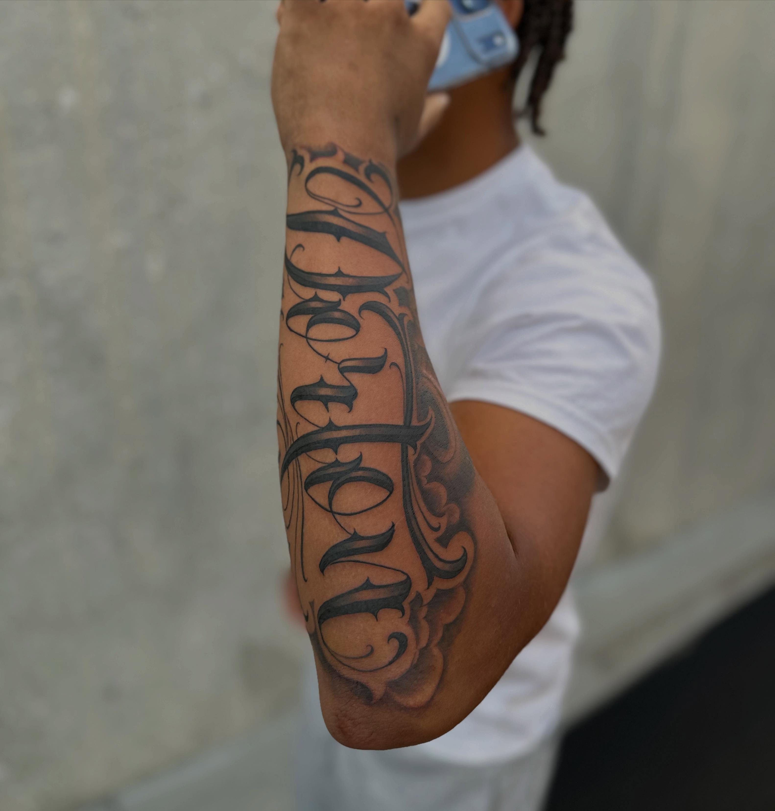 Script lettering lettering script tattoo on the forearm by Ruben