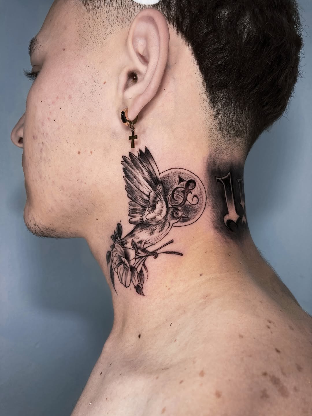Bird with flowers and moon fine line tattoo on the neck by Alvaro