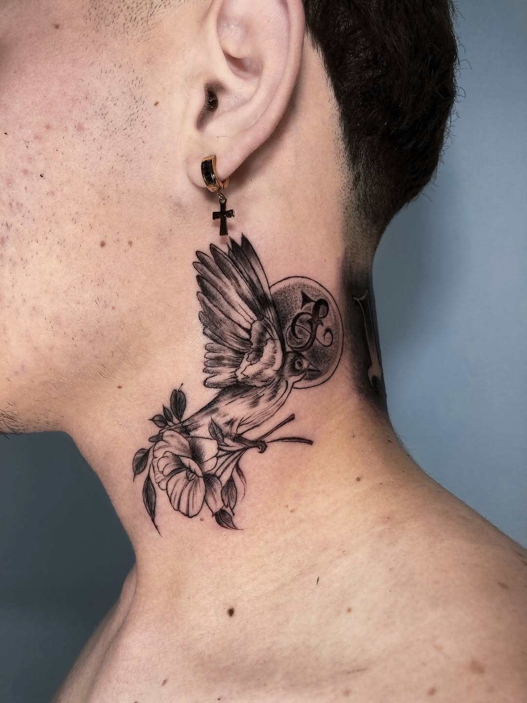 Bird and flower fine line tattoo on the neck by Alvaro