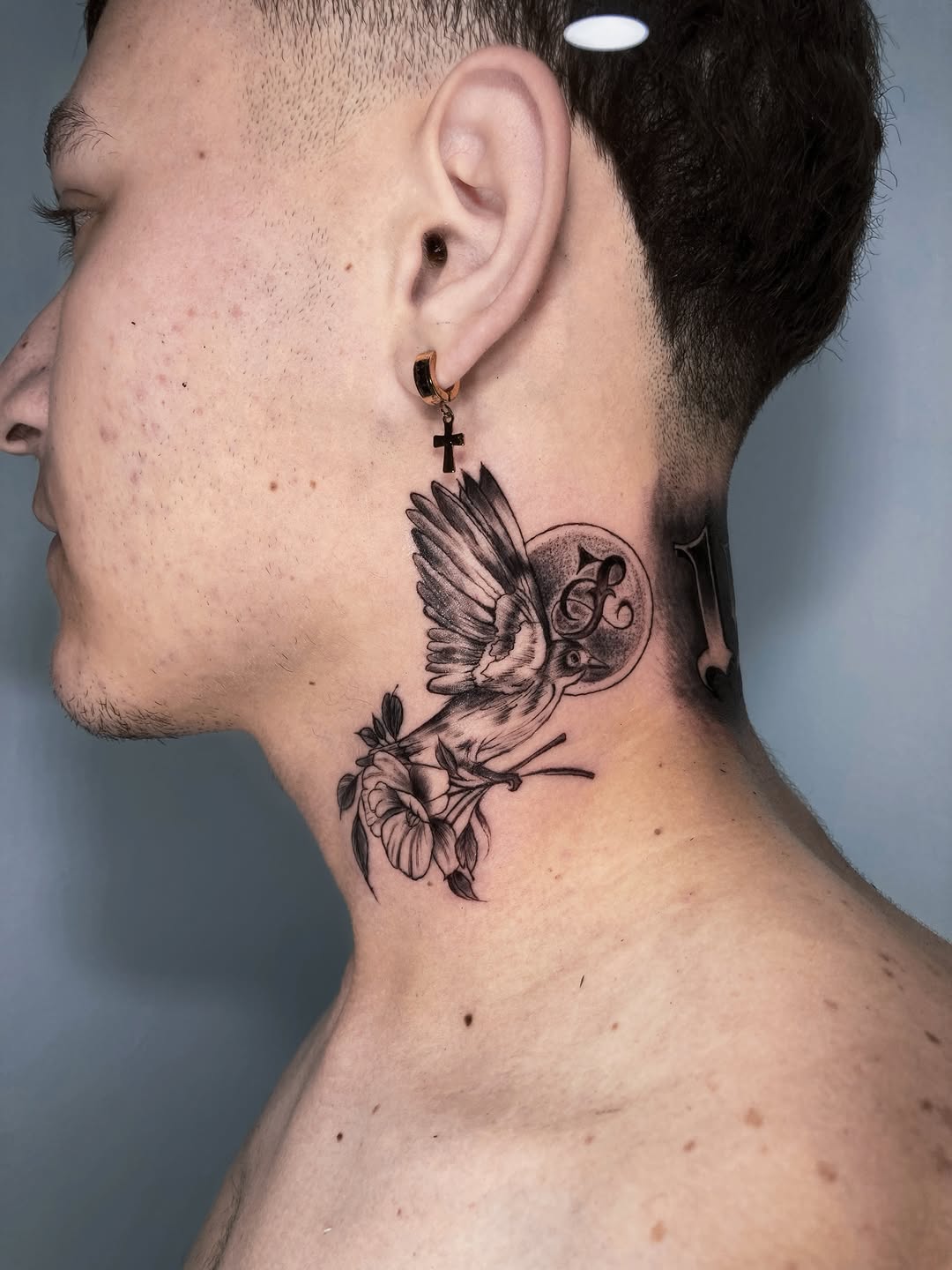 Bird and flower fine line tattoo on the neck by Alvaro