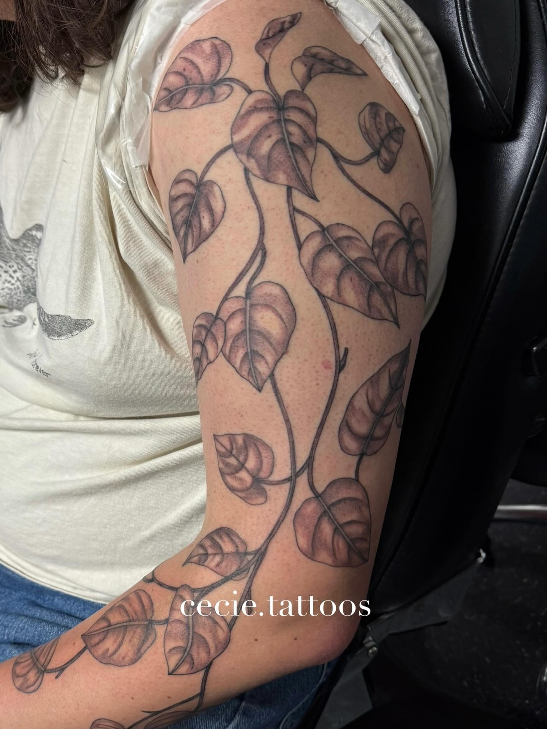 Leaf vine black and grey tattoo on the upper arm by cecie moua