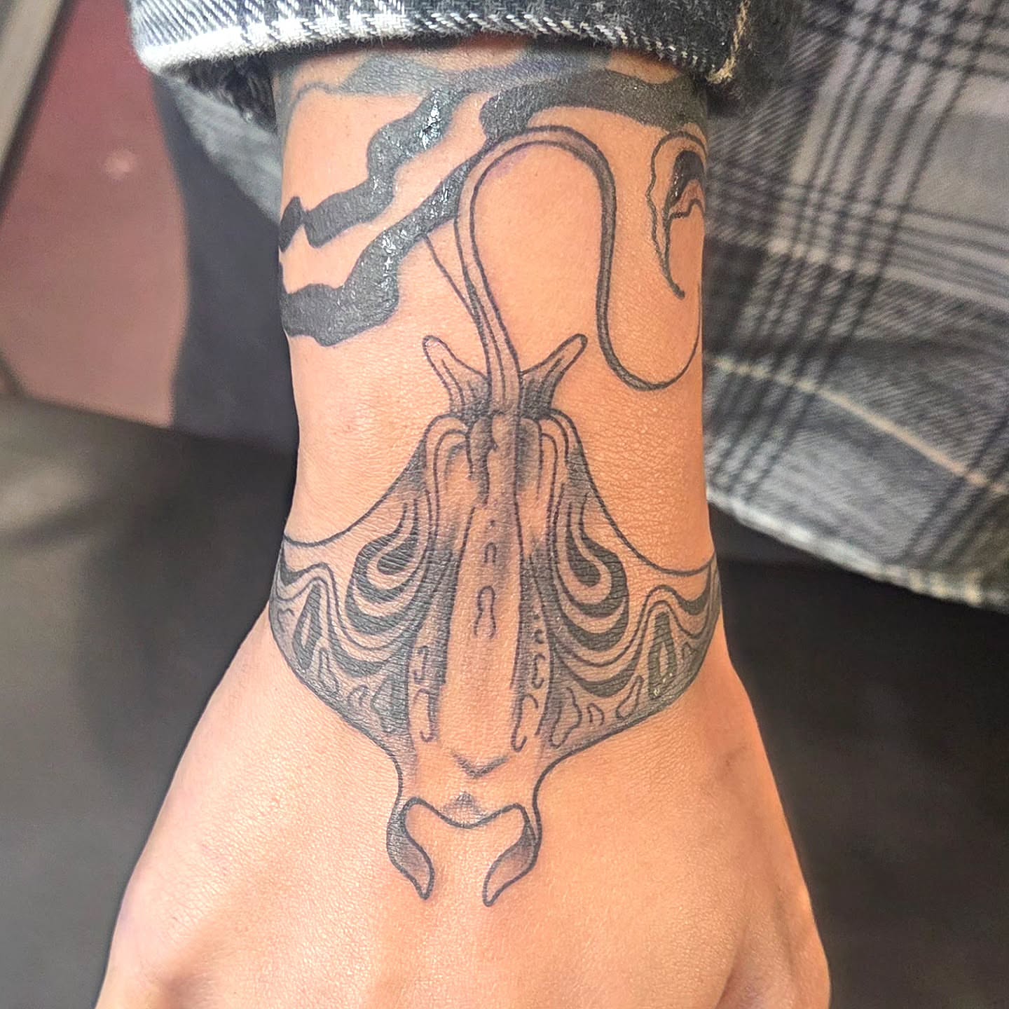 Octopus black and grey tattoo on the forearm by Kat Coniglio Art