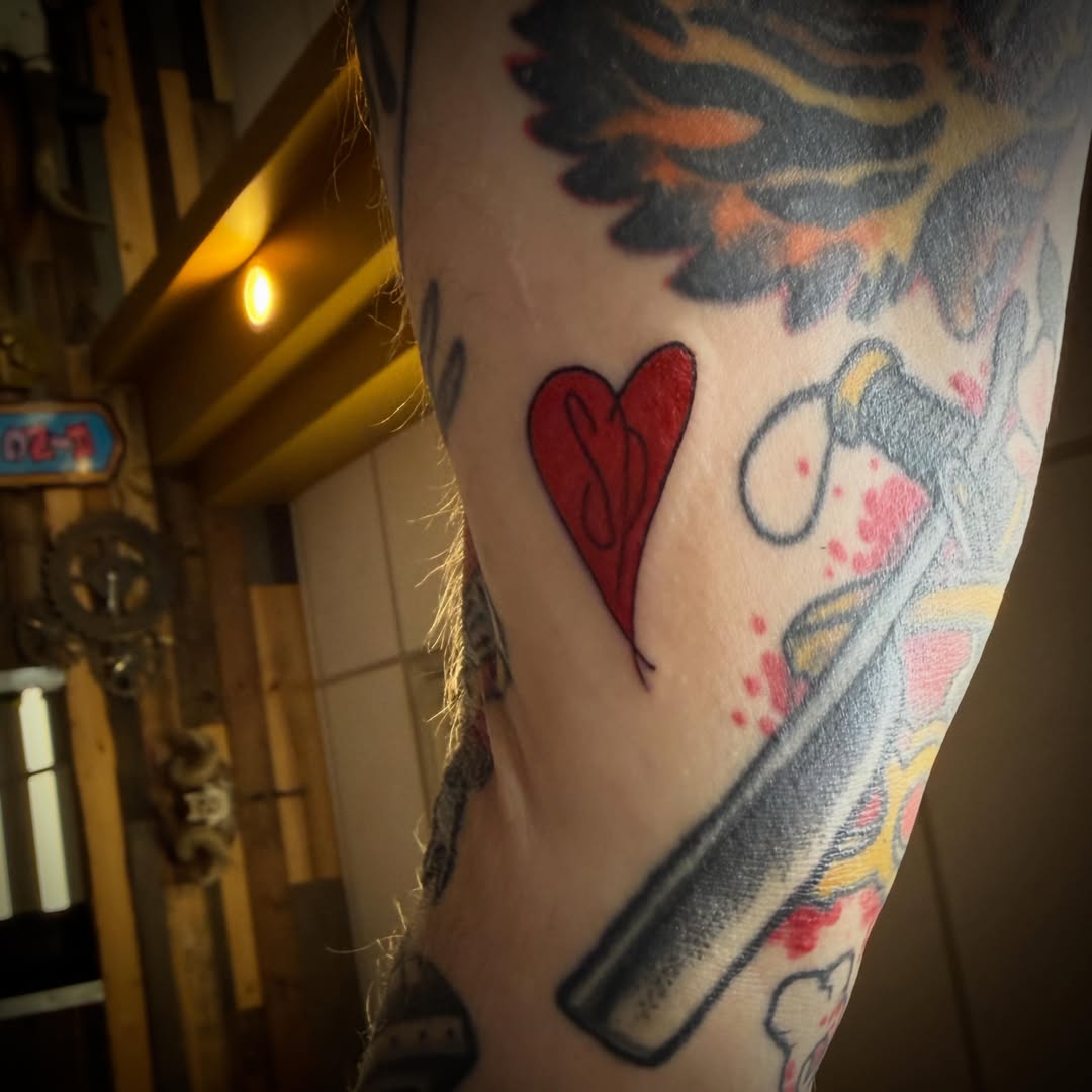 Heart with knife American traditional tattoo on the forearm by ArJay Smith