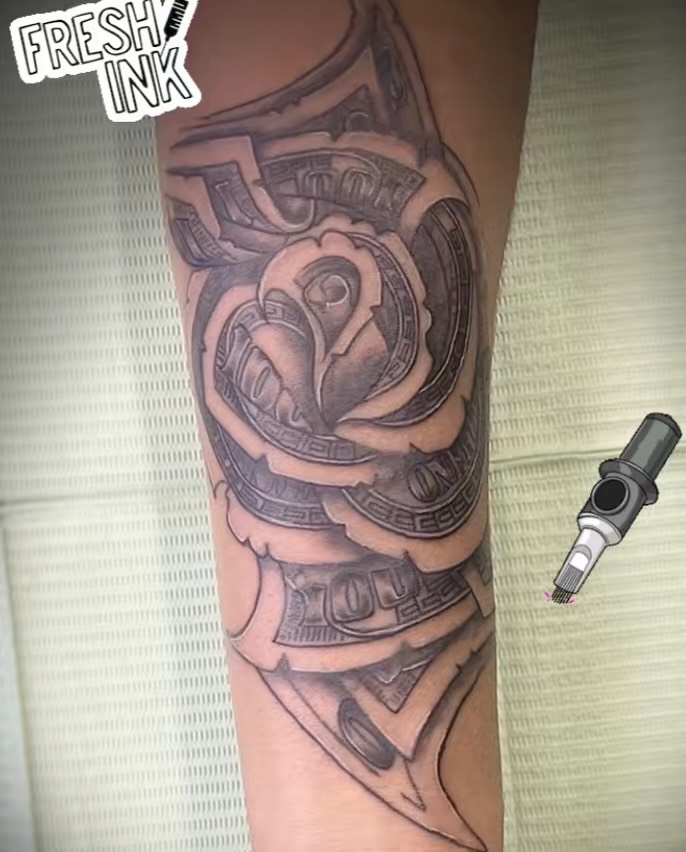 Rose made of money lettering tattoo on the forearm by Christhian King
