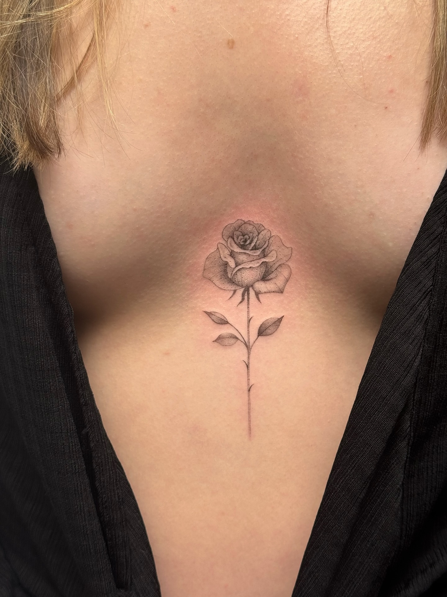 Rose black and grey tattoo on the chest by Lea Burkard, Berkeley, California