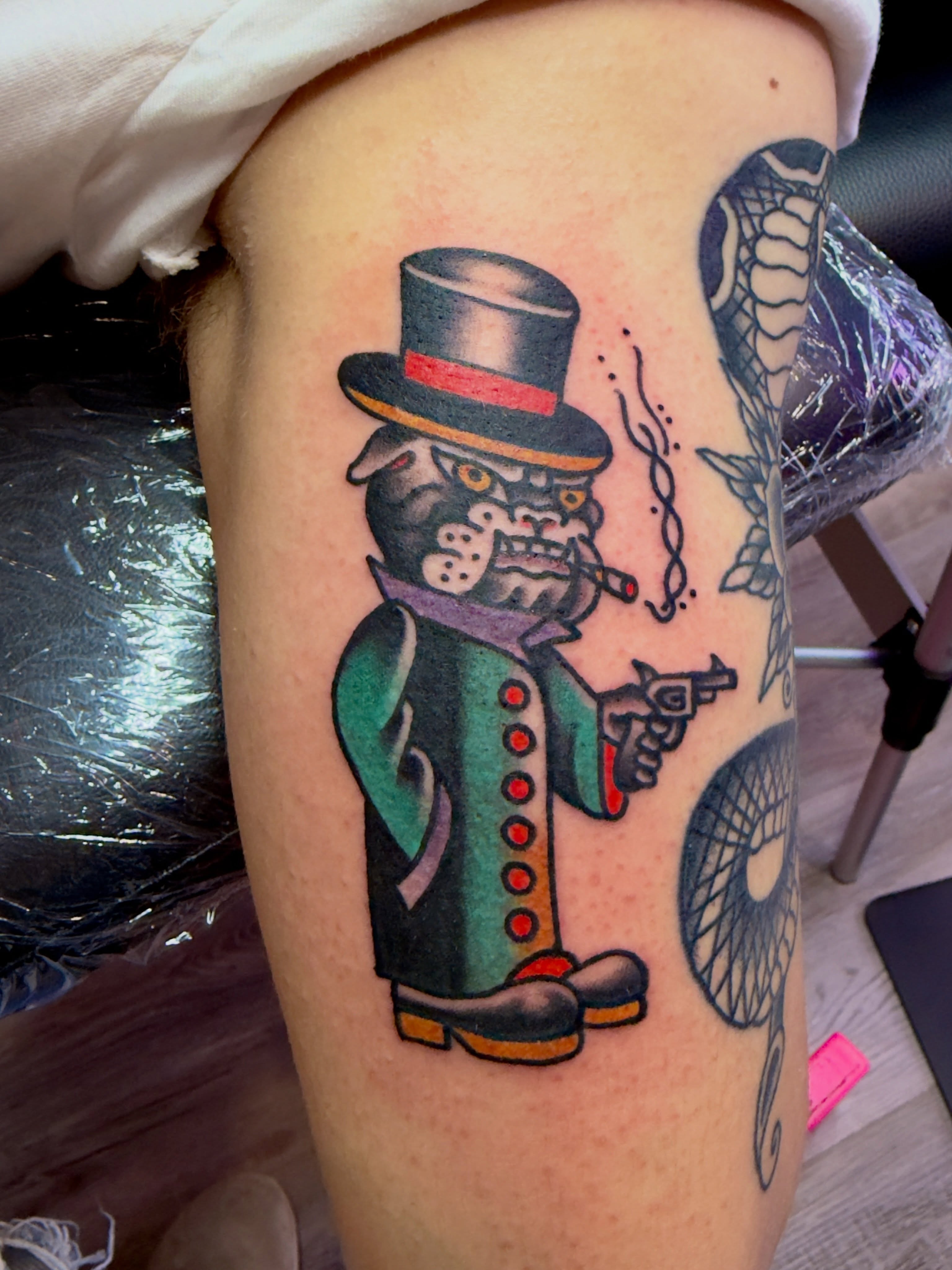 Cat in top hat American traditional tattoo on the thigh by Jimmy Kelley