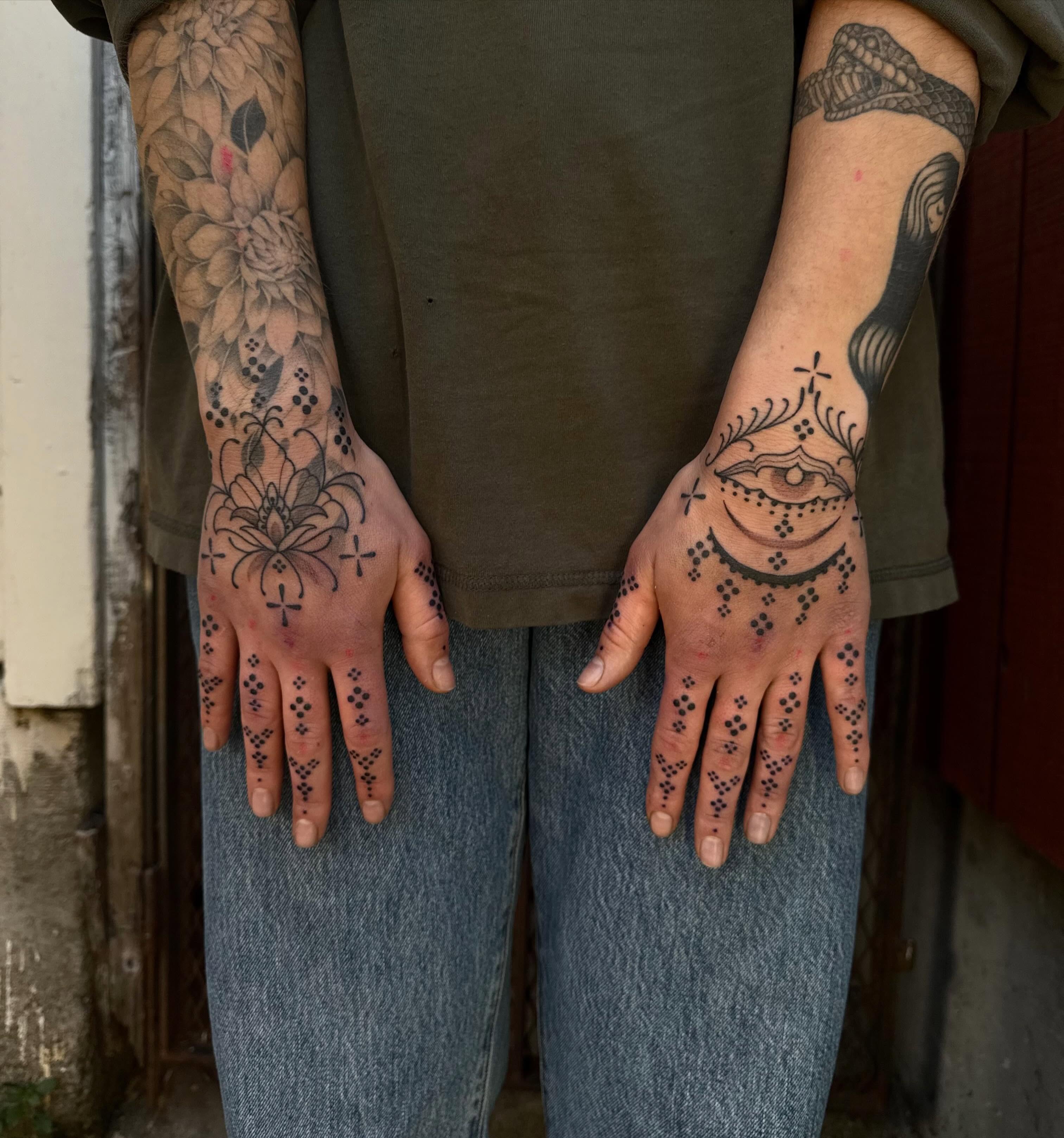Eye and floral patterns dotwork tattoo on the hand by Erin Shea