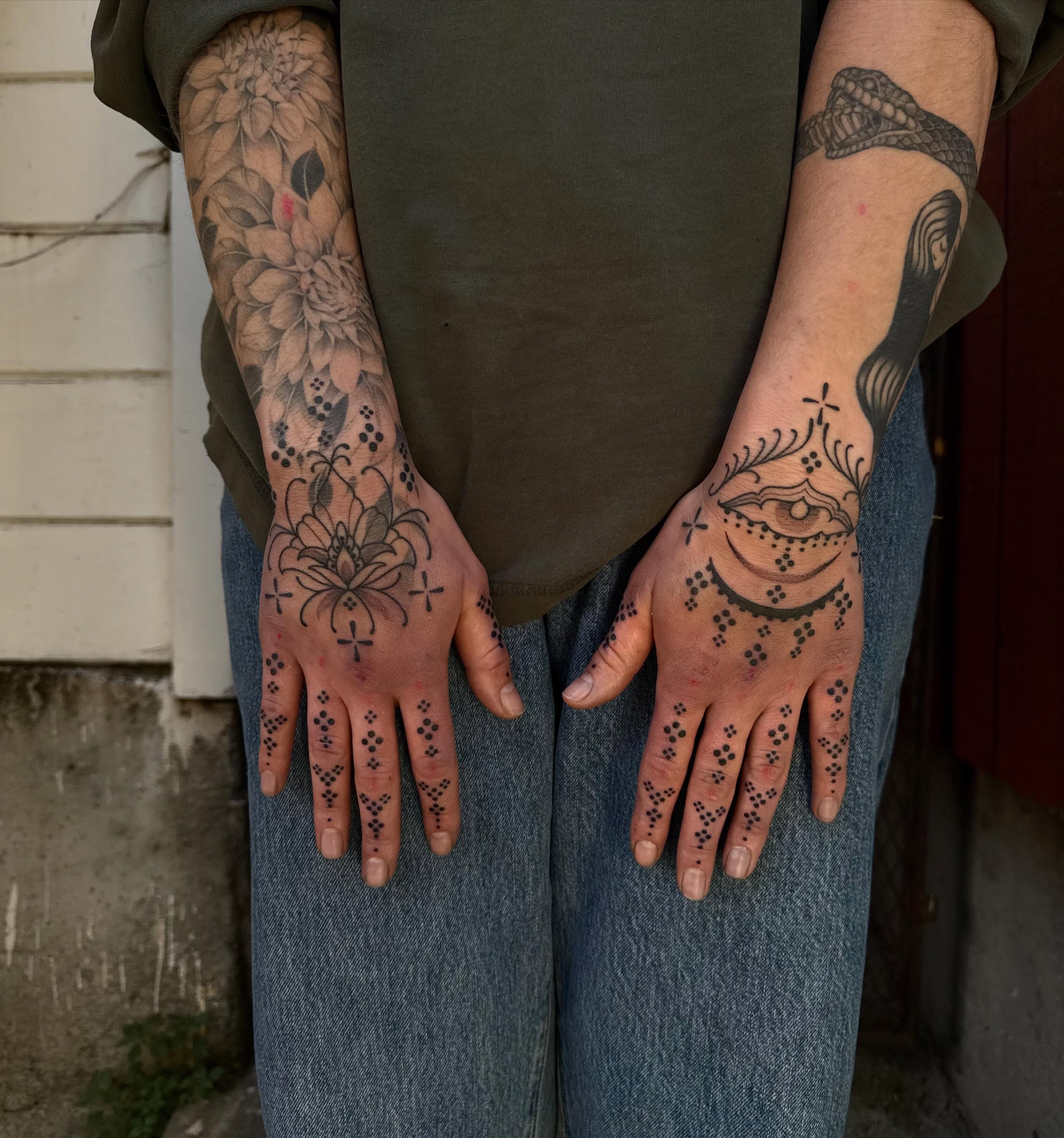Floral and abstract patterns dotwork tattoo on the hand by Erin Shea