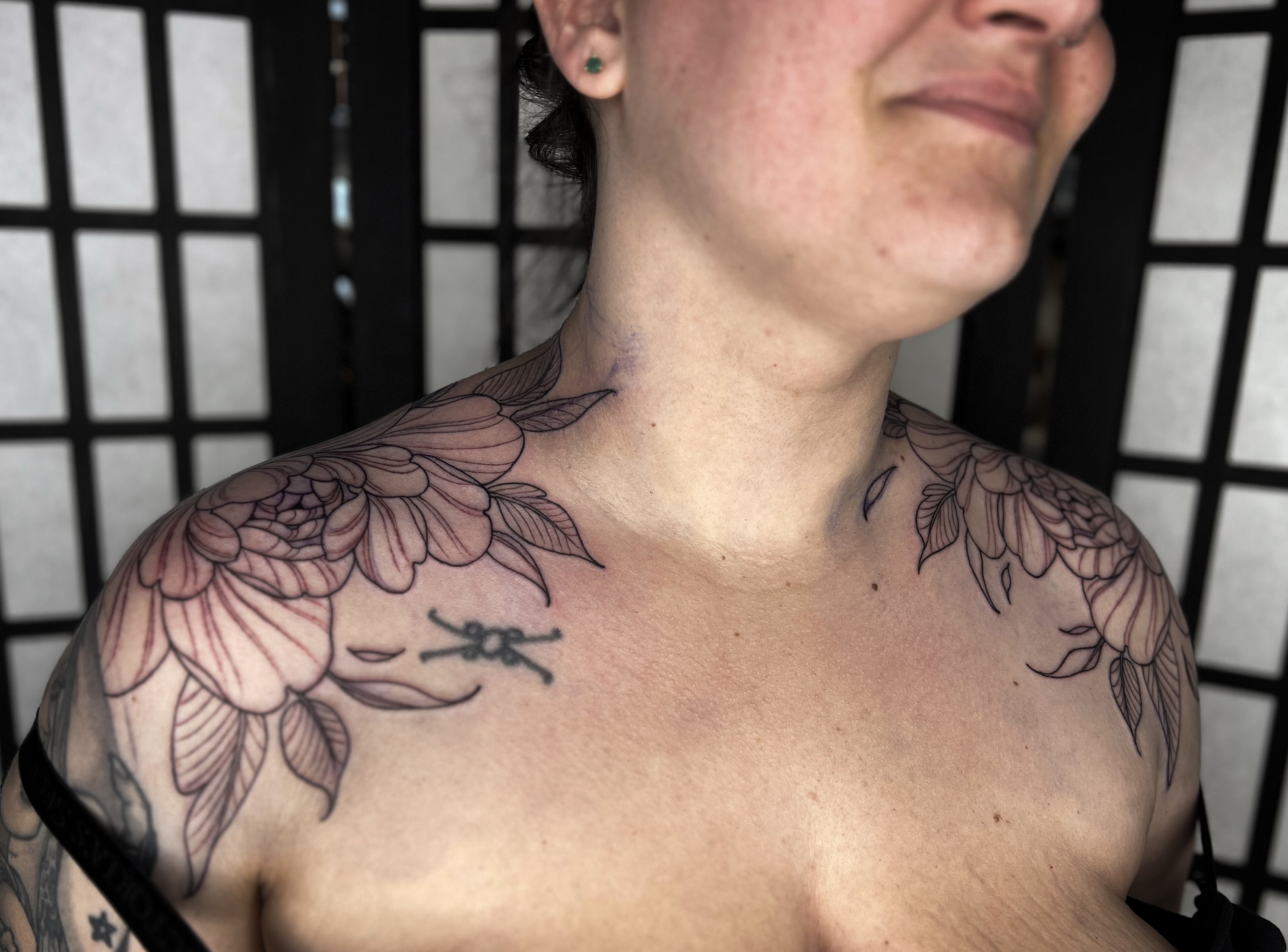 Floral arrangement black and grey tattoo on the chest by Kaysee Shuster