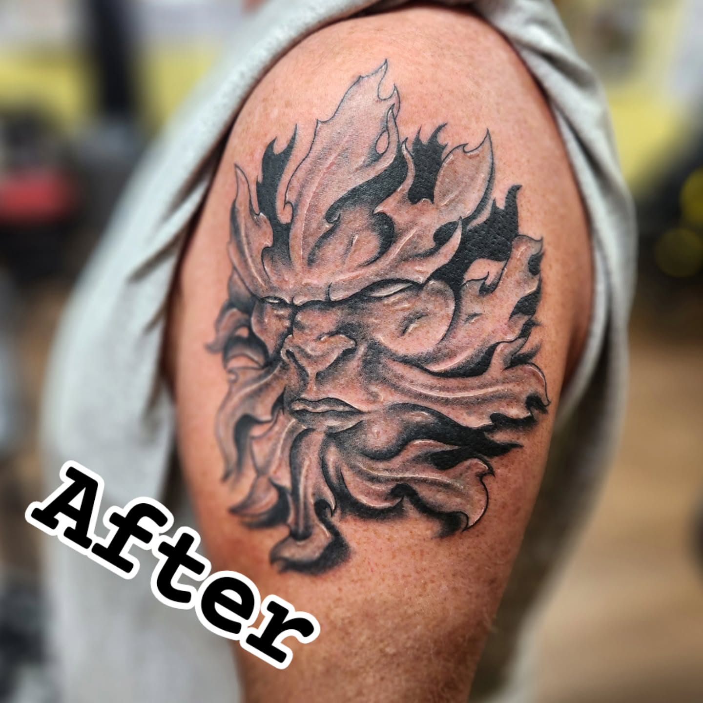 Flame black and grey tattoo on the shoulder by Eric Richards