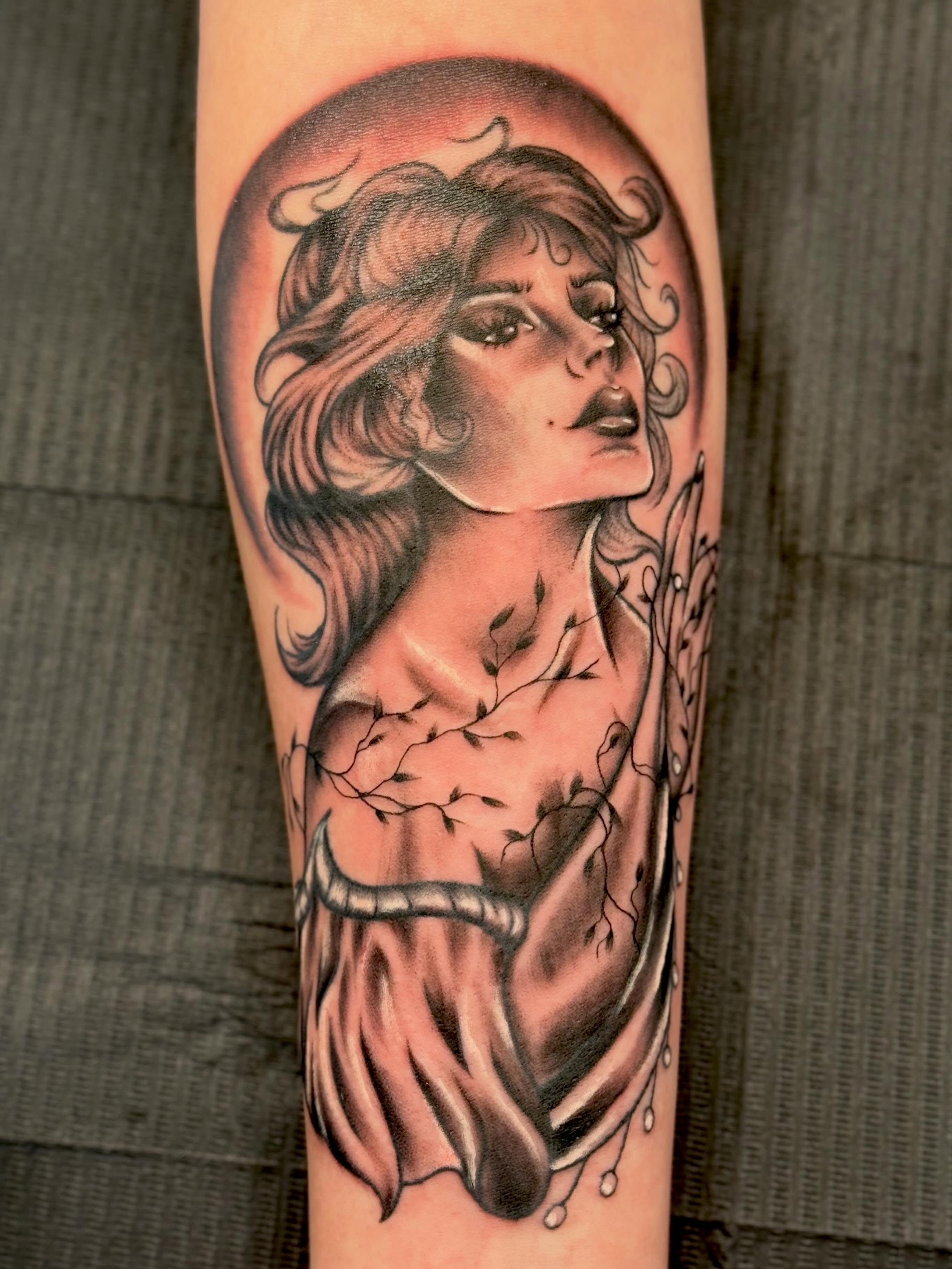 Woman with flowing hair realism tattoo on the forearm by Serenity Mullins