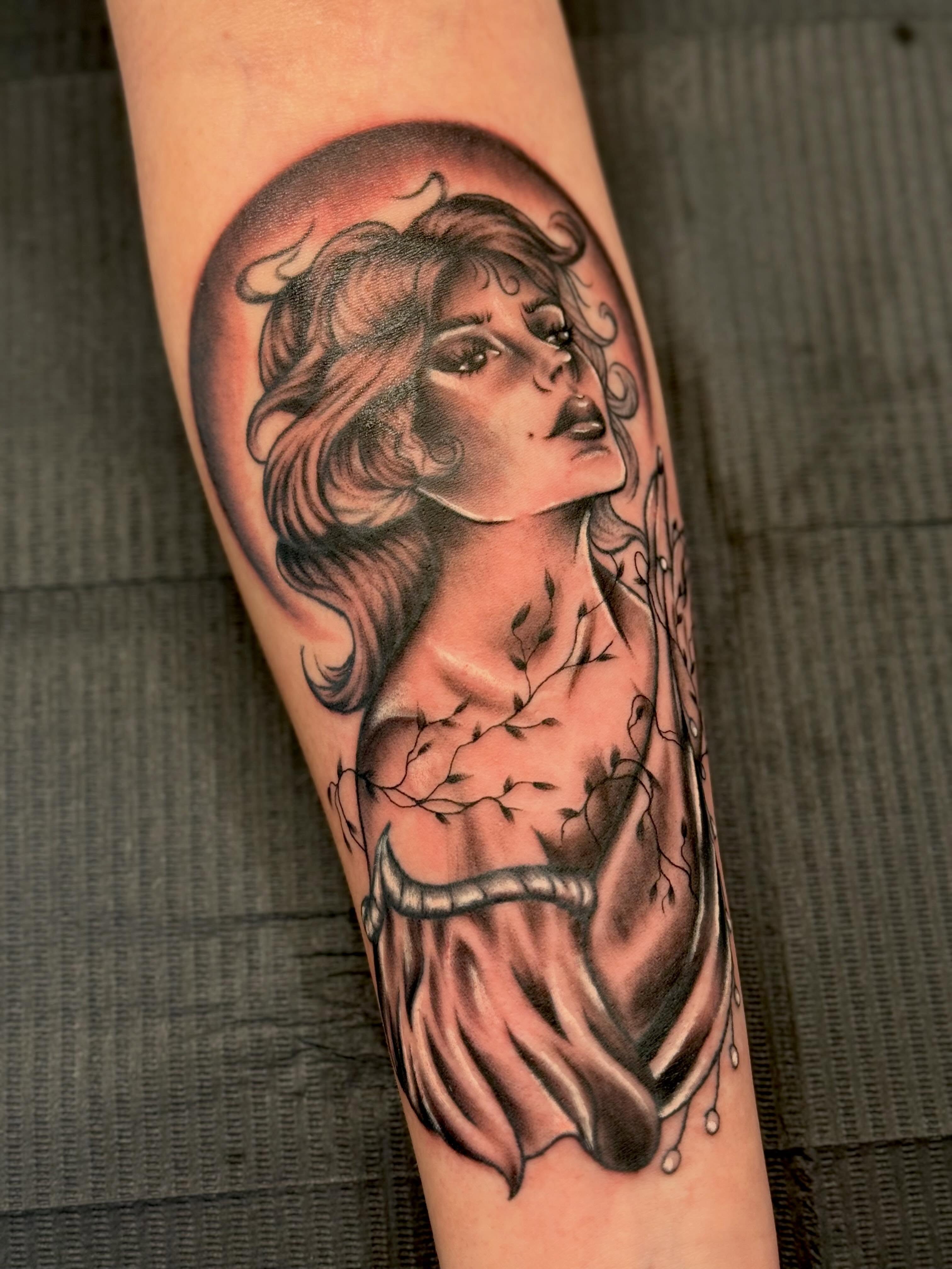 Woman with flowing hair realism tattoo on the forearm by Serenity Mullins