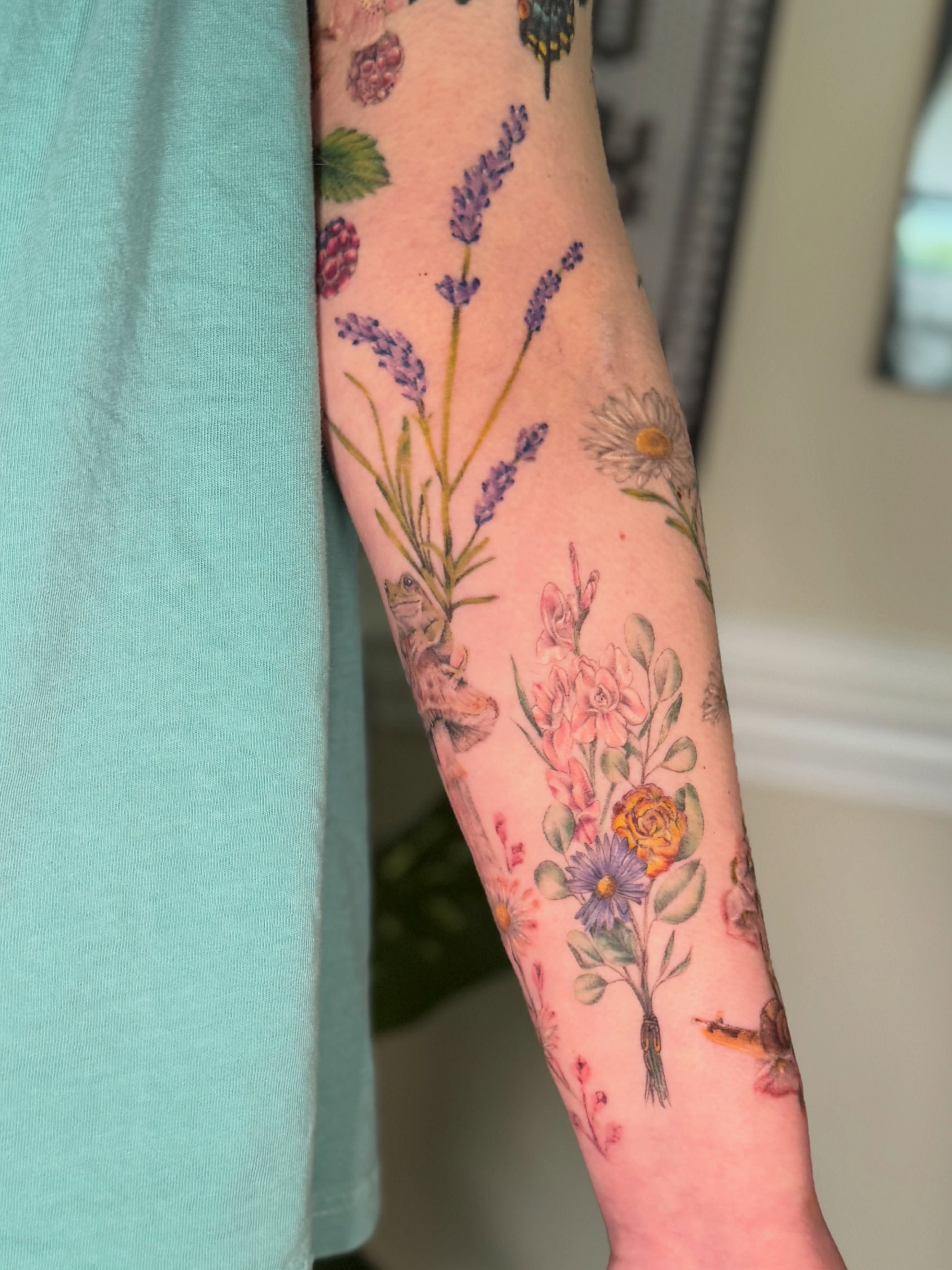 Floral arrangement watercolor tattoo on the forearm by Chiah
