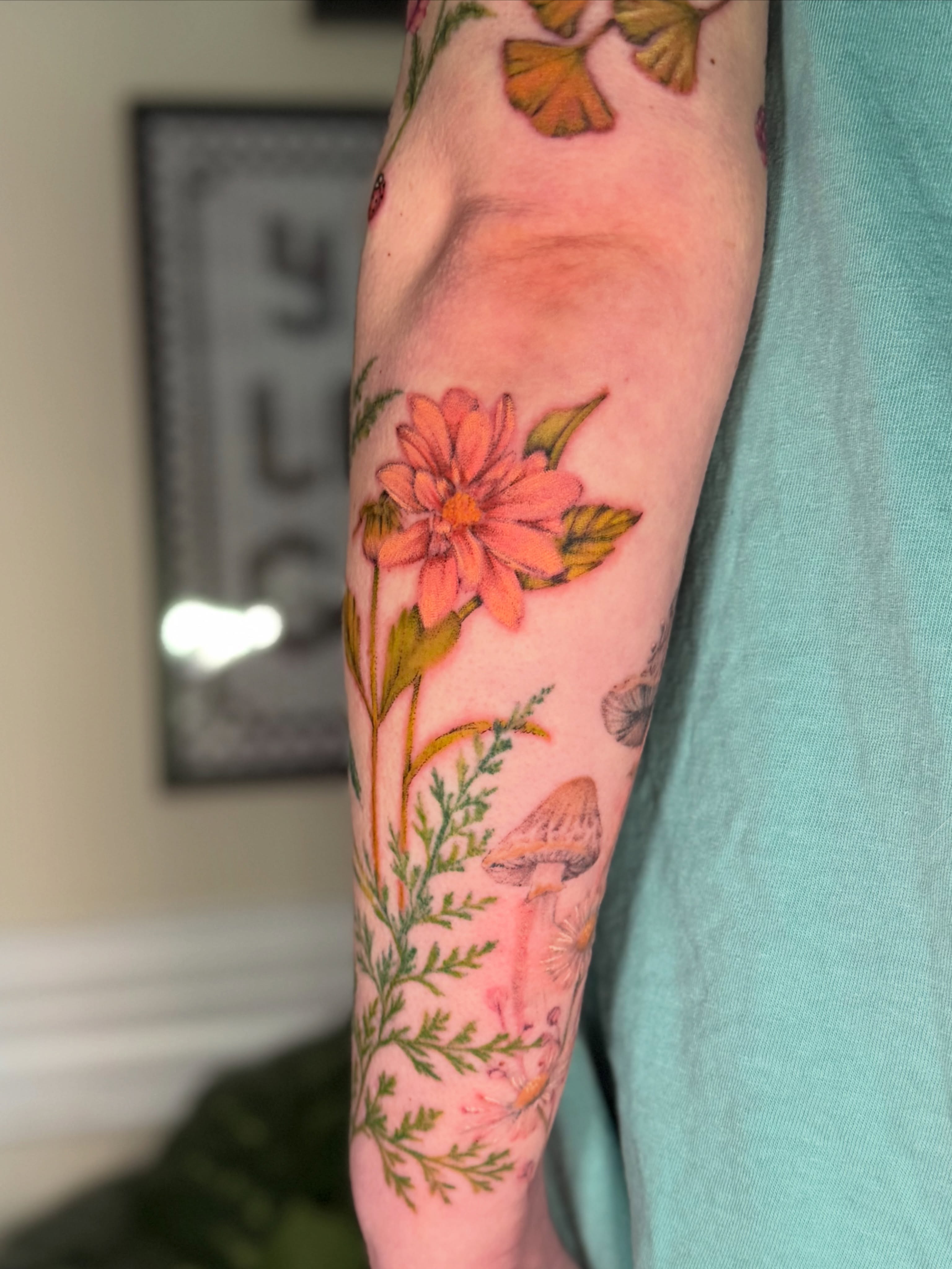 Flower and mushrooms realism tattoo on the forearm by Chiah