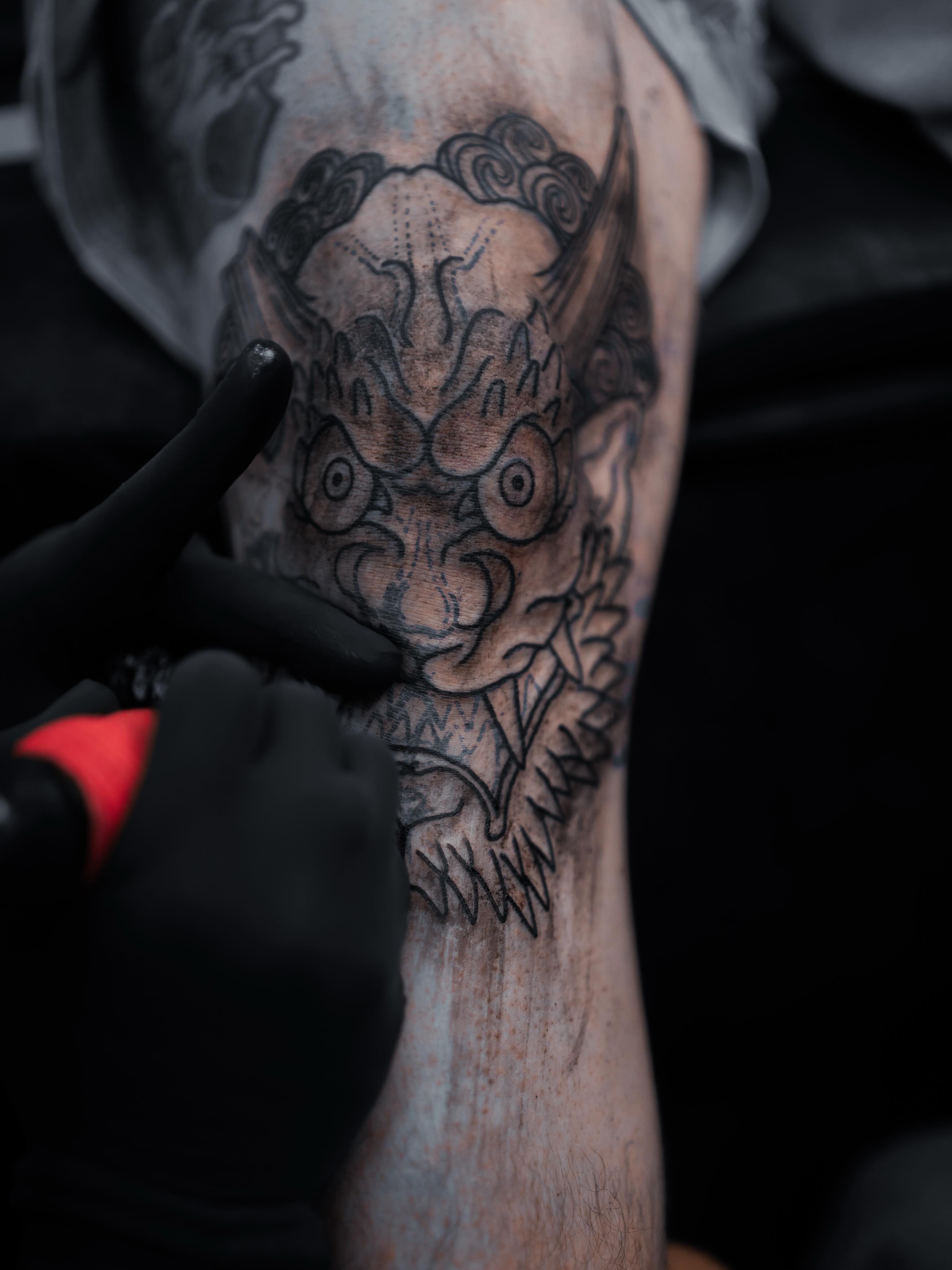 Demon mask black and grey tattoo on the forearm by Don Peddicord