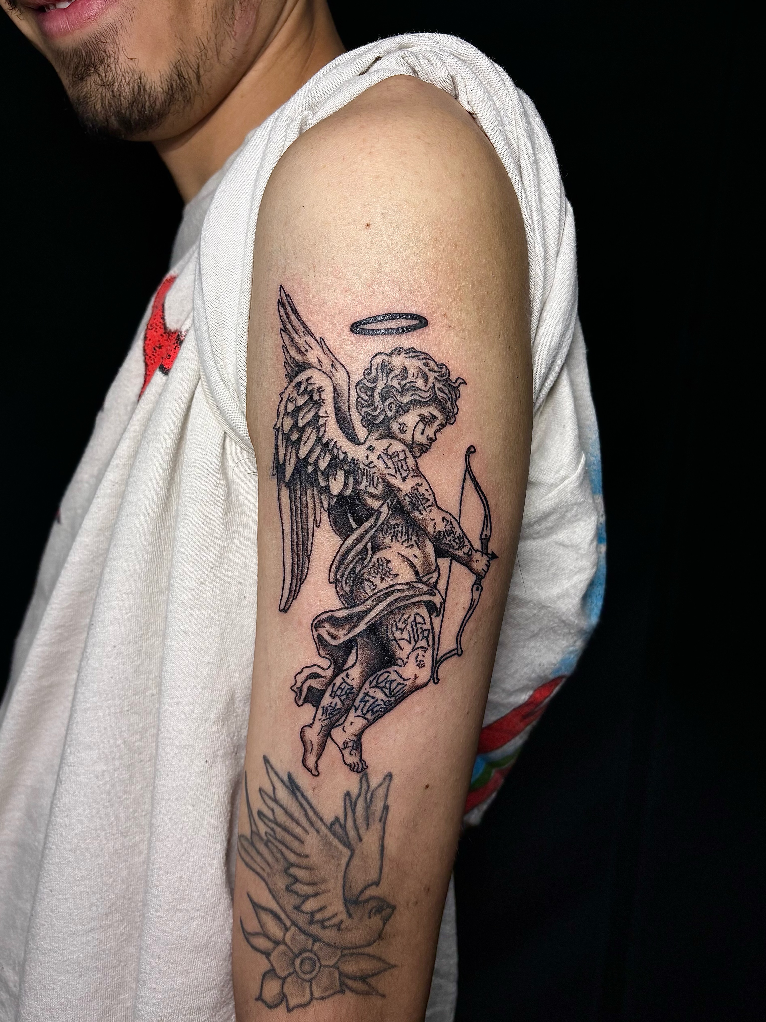 Angel with bow black and grey tattoo on the forearm by JT.tattoos