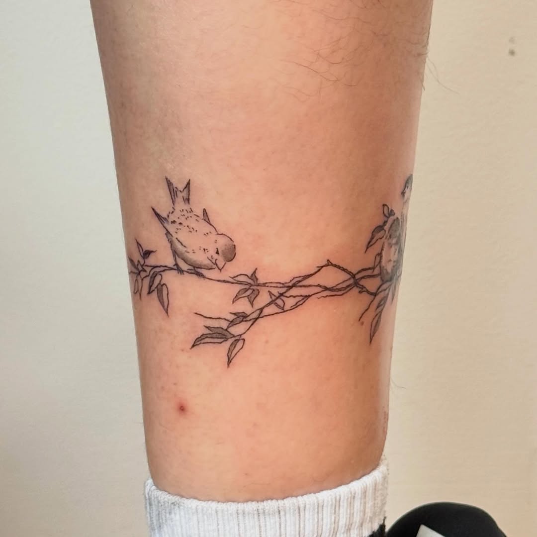 Bird on a branch fine line tattoo on the forearm by Kirsten