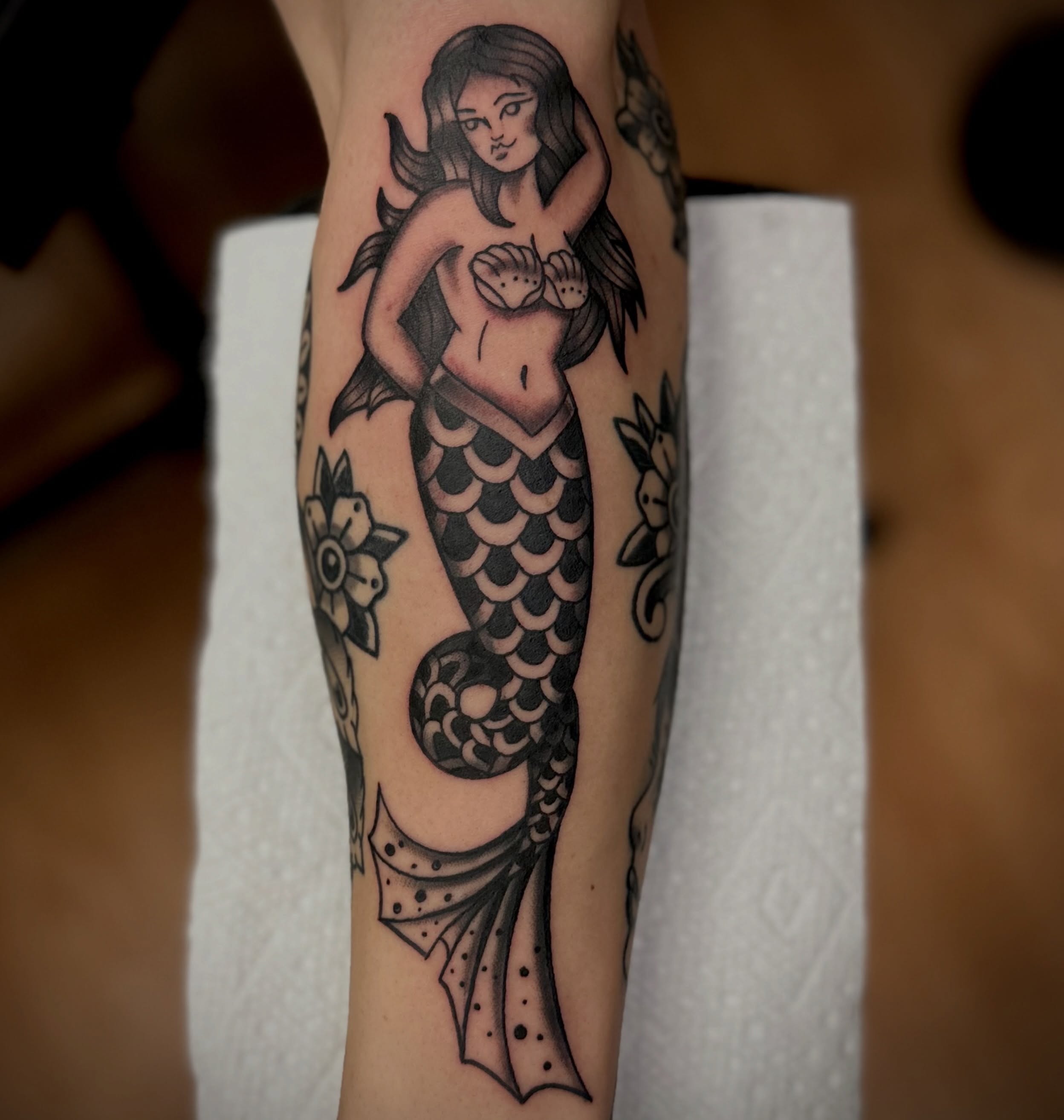 Mermaid American traditional tattoo on the forearm by Josh Robinson