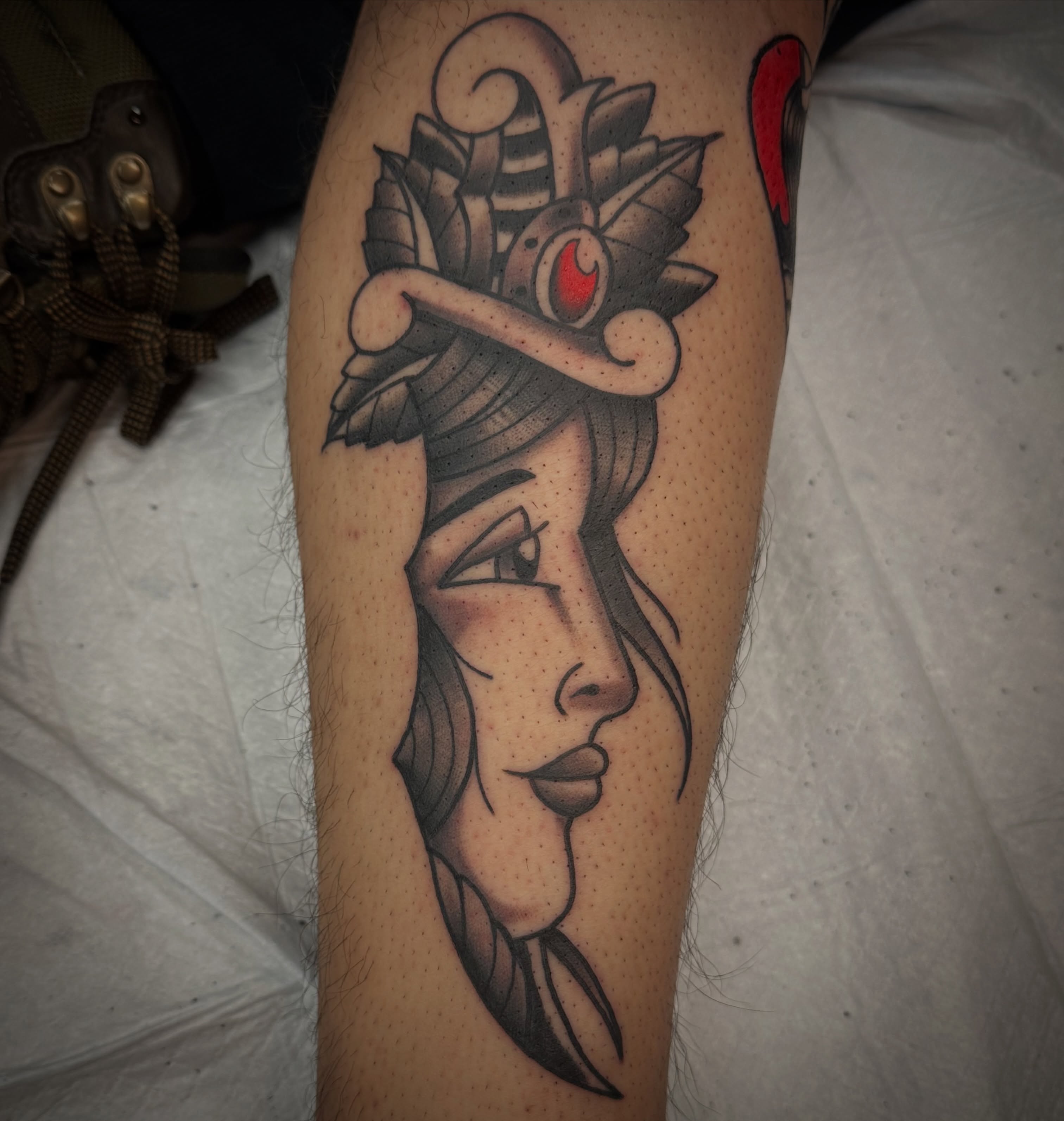 Woman's profile American traditional tattoo on the forearm by Josh Robinson