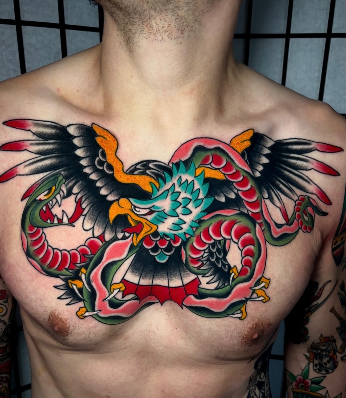 Dragon and eagle American traditional tattoo on the chest by Mickey Putillo, Charlotte, North Carolina