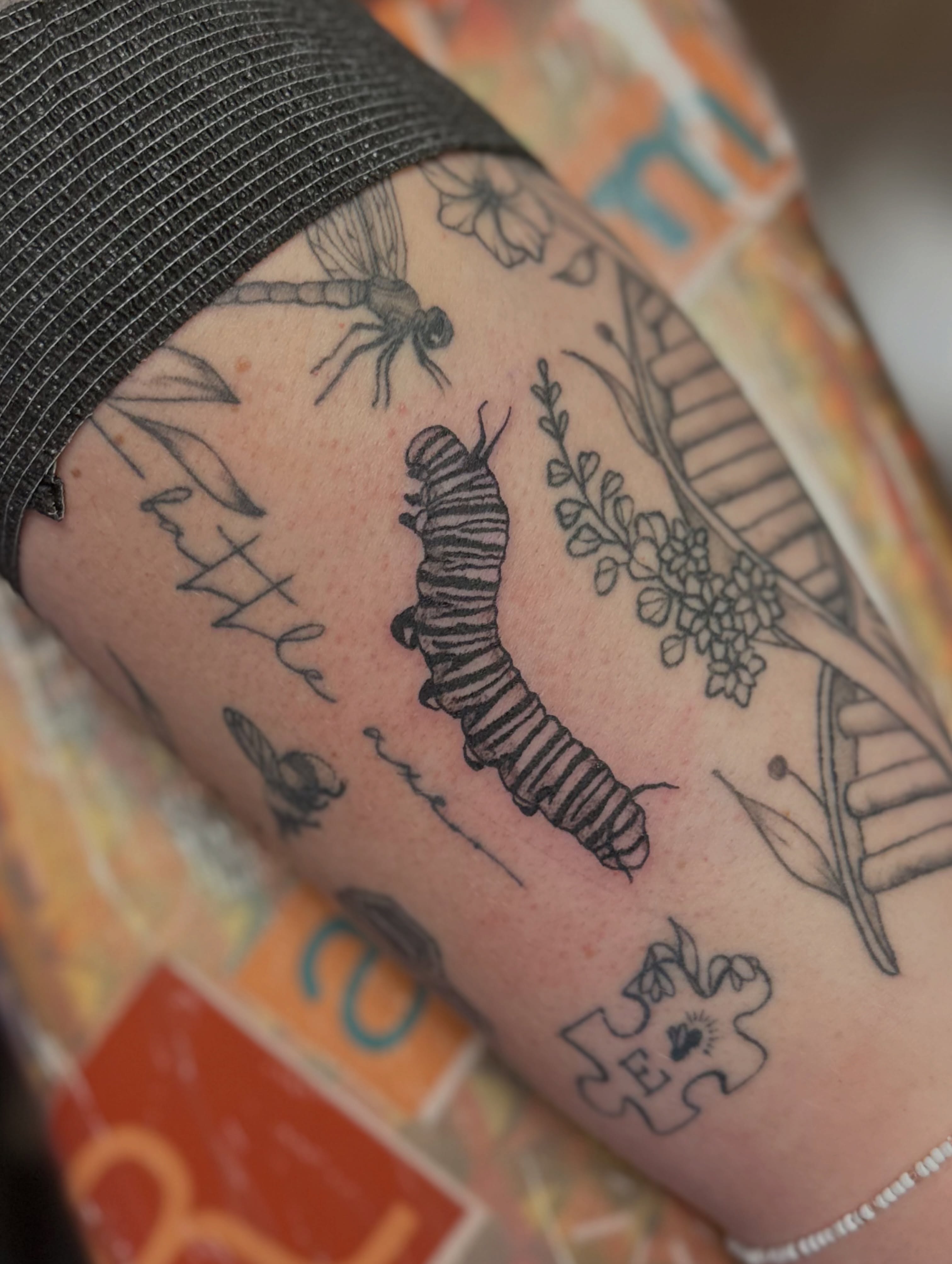 Caterpillar life cycle black and grey tattoo on the forearm by Ransom