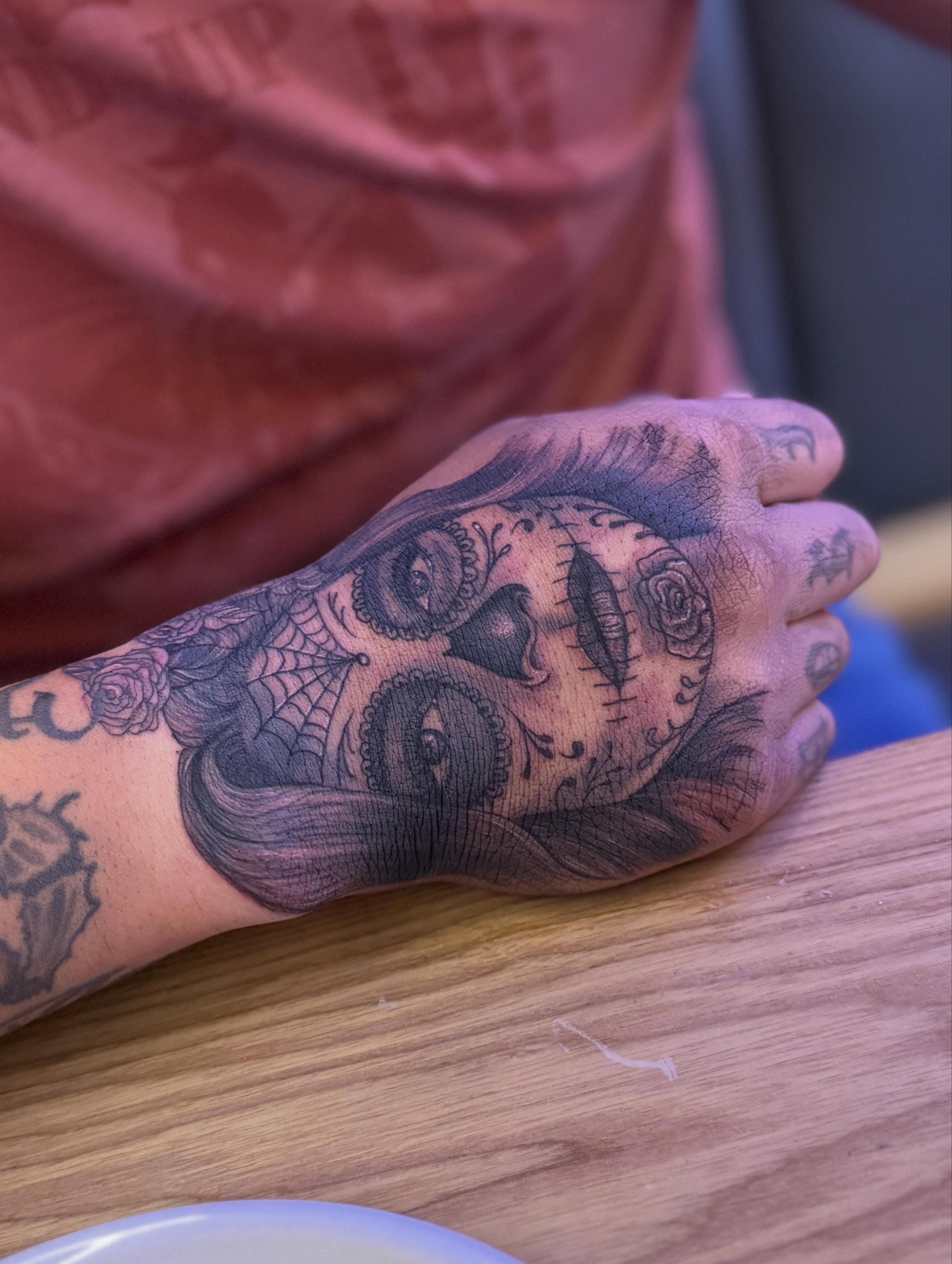 Sugar skull Chicano tattoo on the hand by Dre