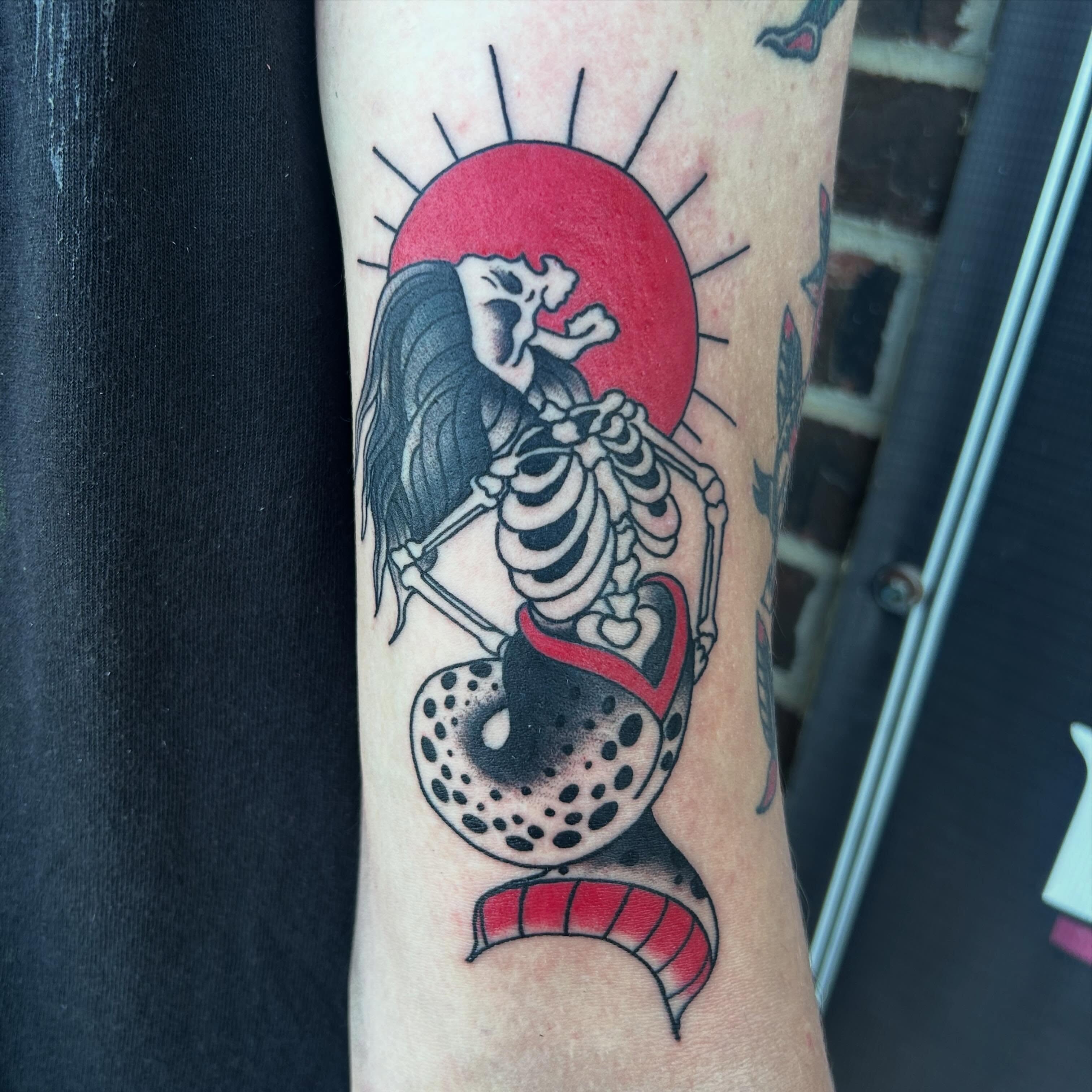 Skeleton with heart American traditional tattoo on the forearm by Zach Andrews