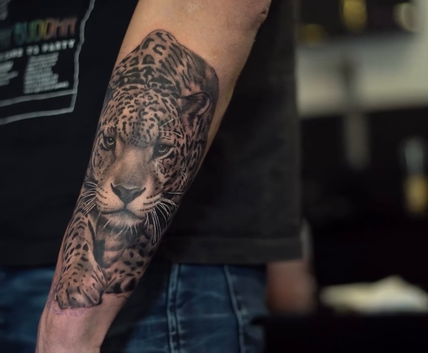 Leopard portrait realism tattoo on the forearm by Remko