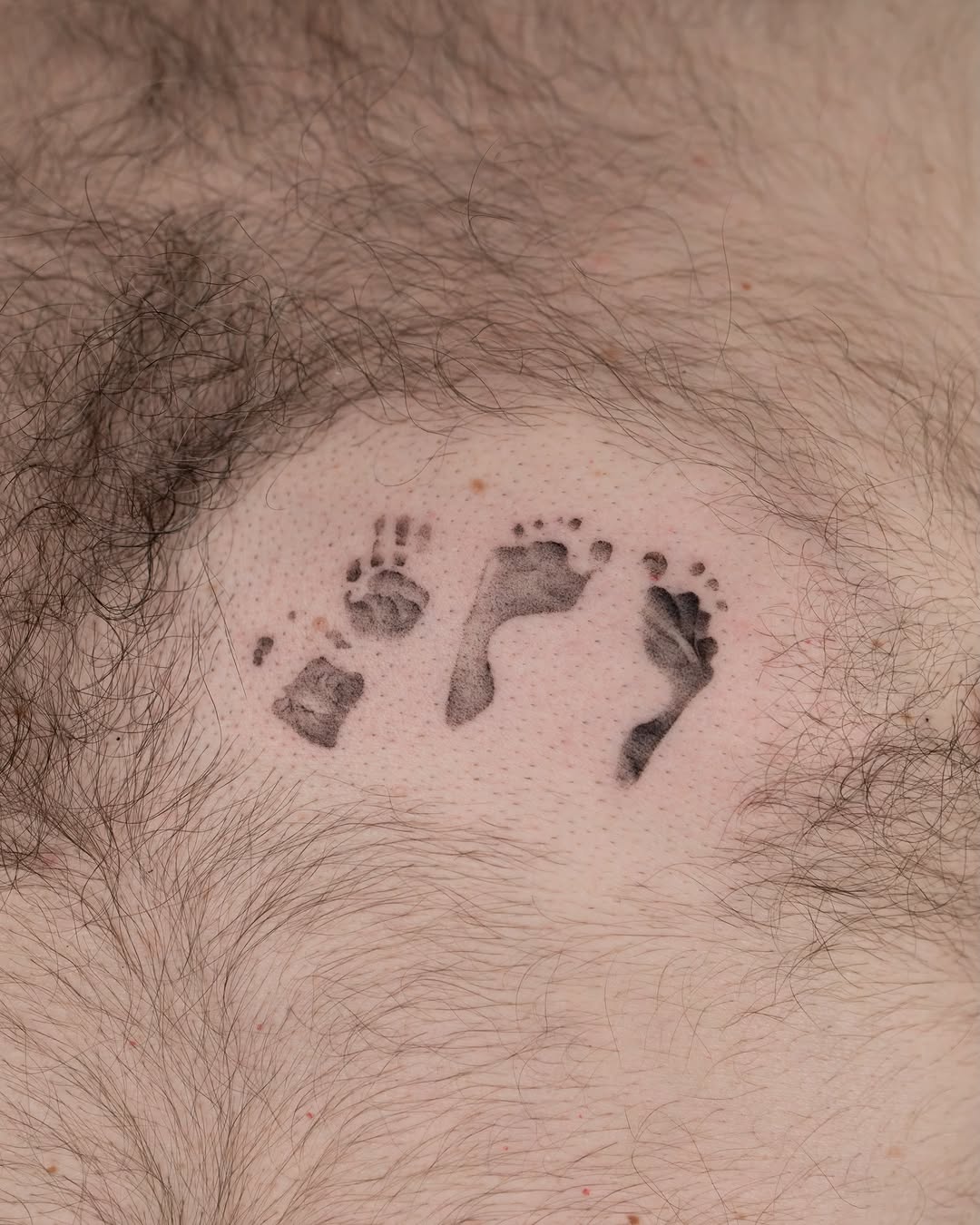 Footprints dotwork tattoo on the chest by t y, t a t t o o a r t i s t