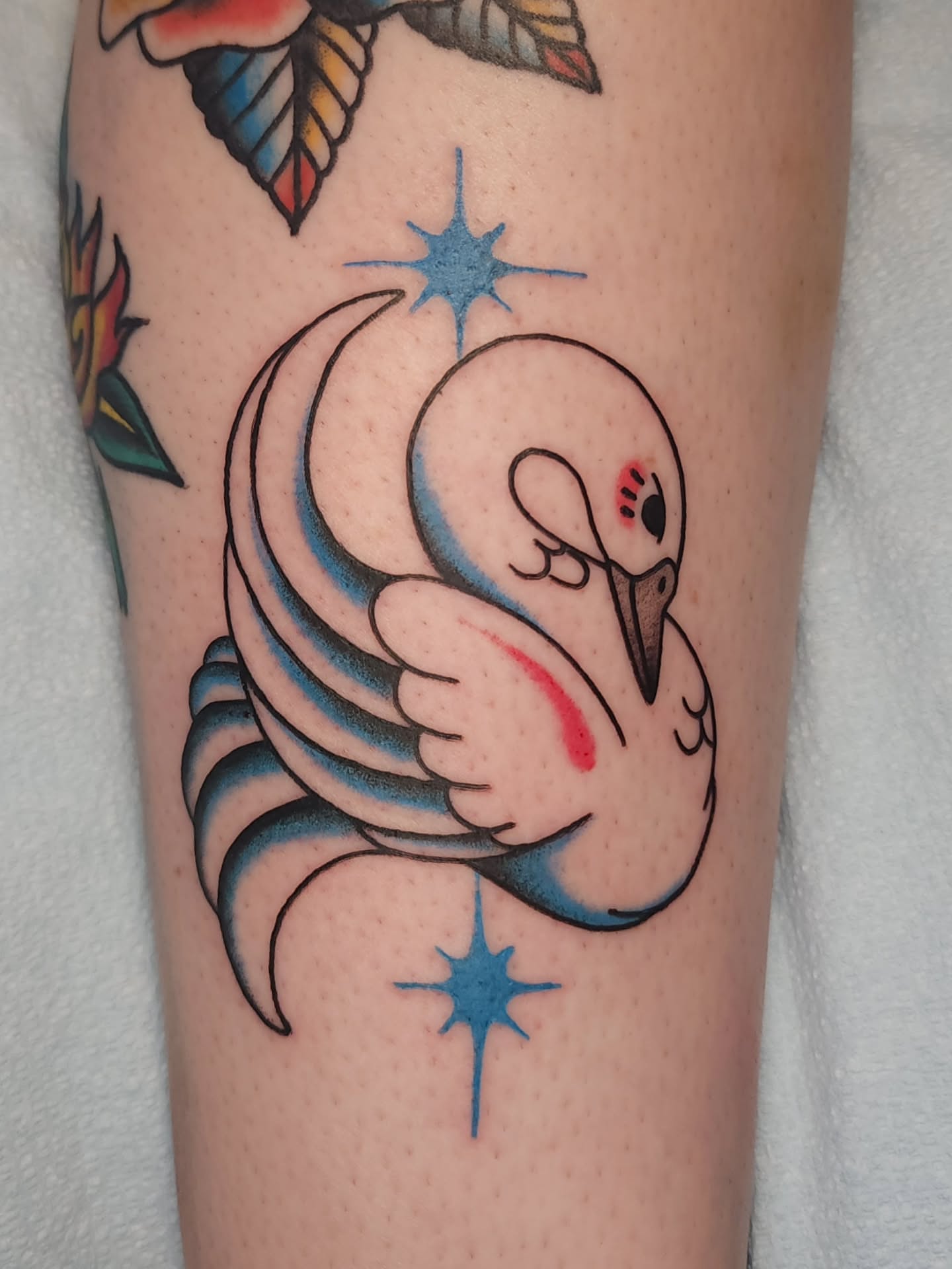 Swan and crescent moon American traditional tattoo on the forearm by Maxine Stewart