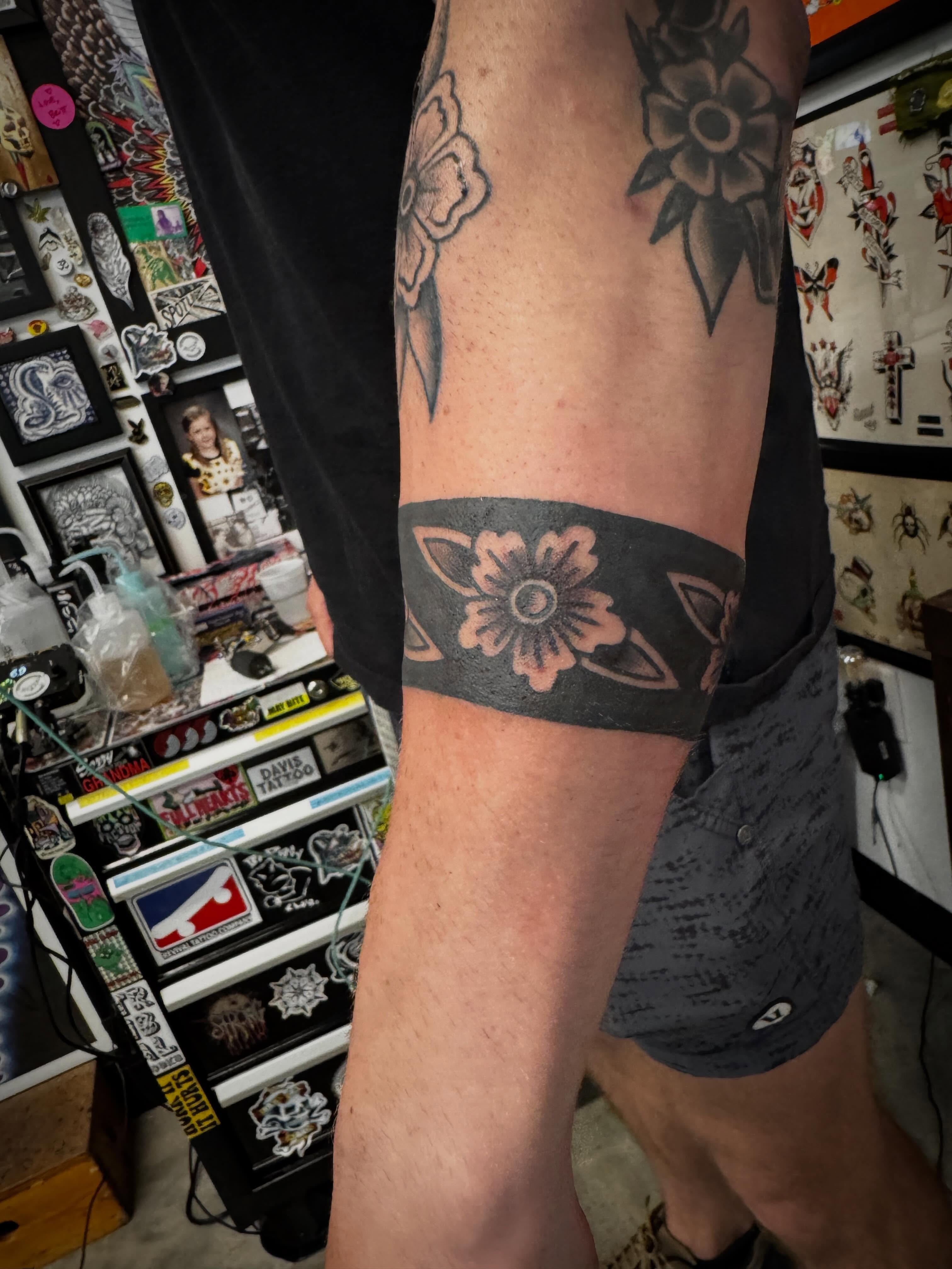 Floral band black and grey tattoo on the forearm by j Smalley