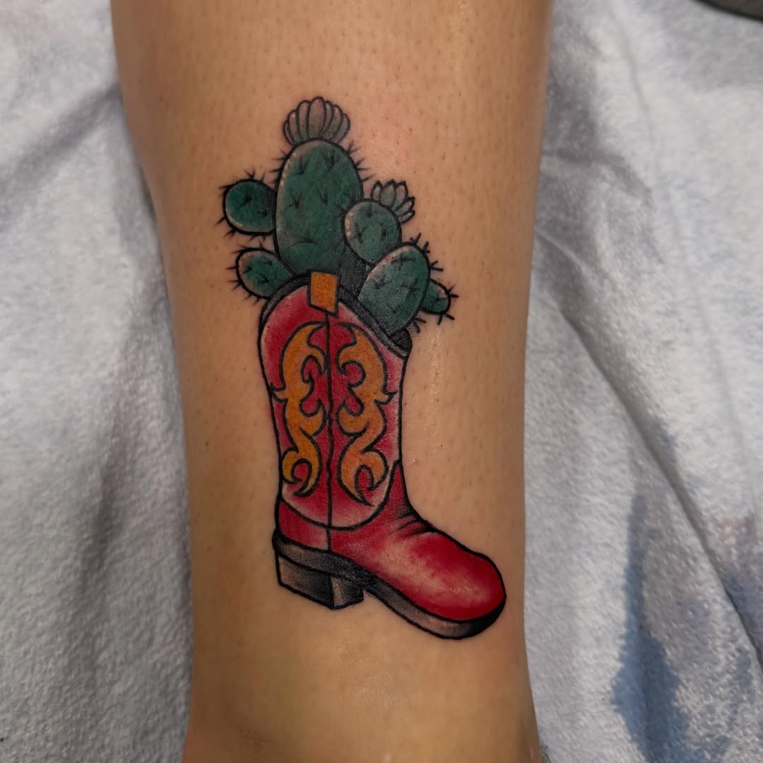Cowboy boot with cactus American traditional tattoo on the forearm by Madilynn Klassen