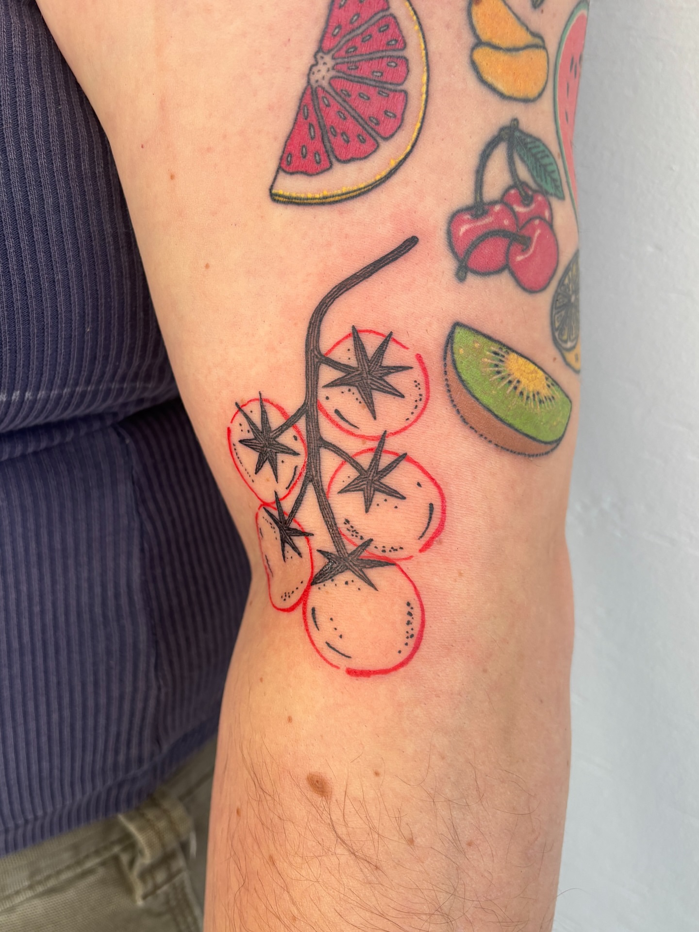 Tomato plant geometric tattoo on the forearm by Raye